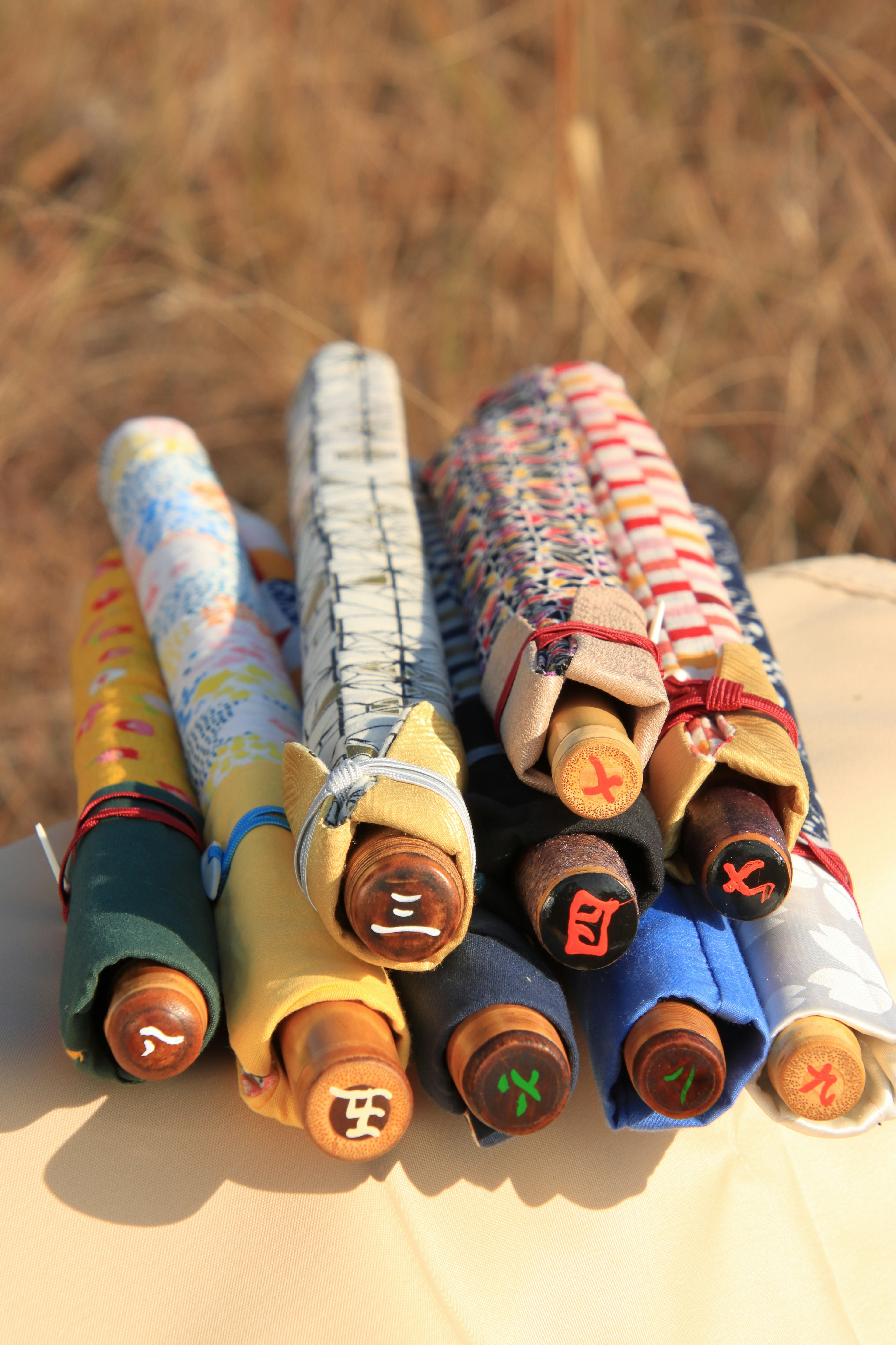 Colorful scrolls wrapped in fabric arranged in a pile