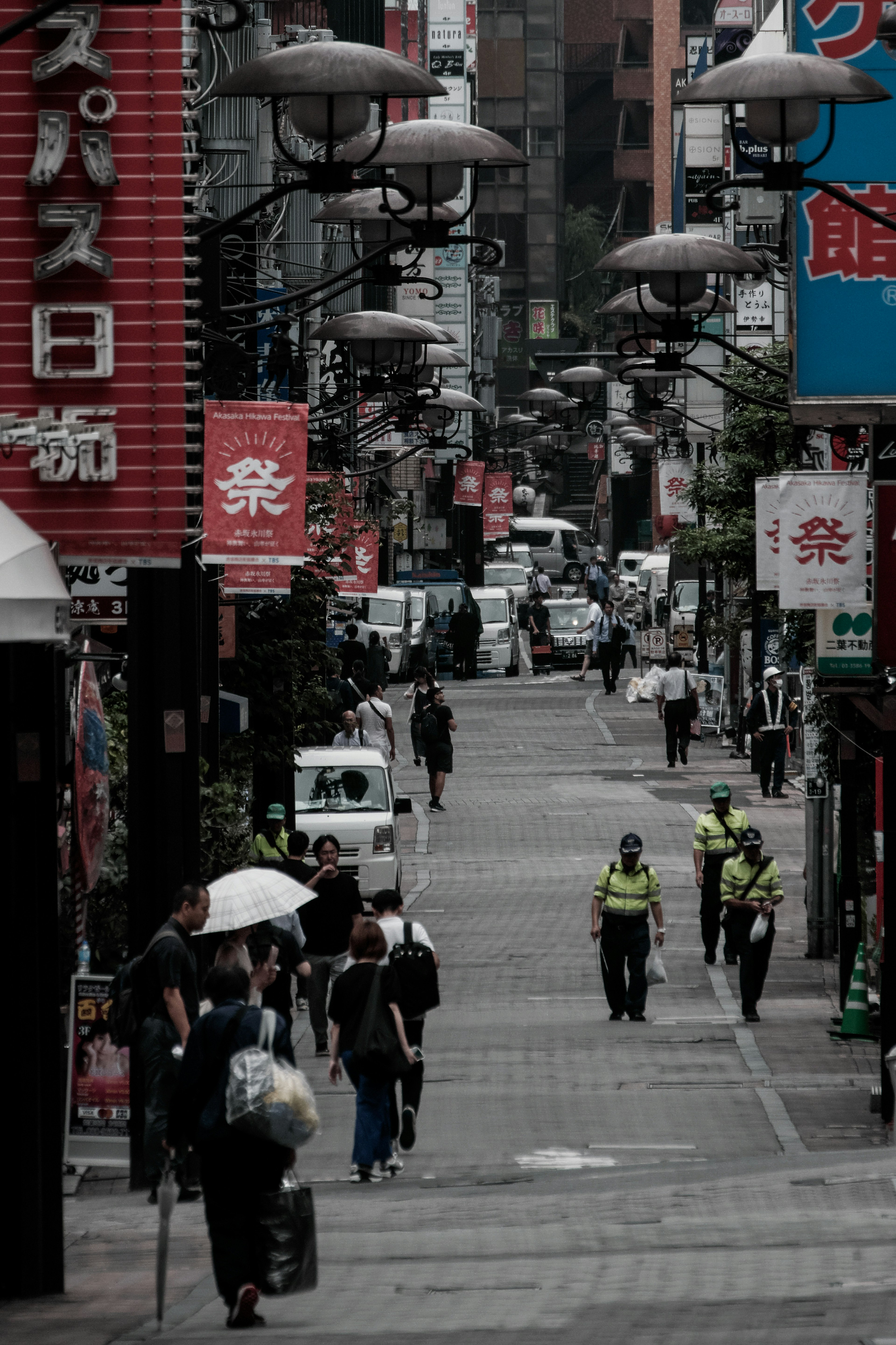 Busy city street with pedestrians and police officers observing