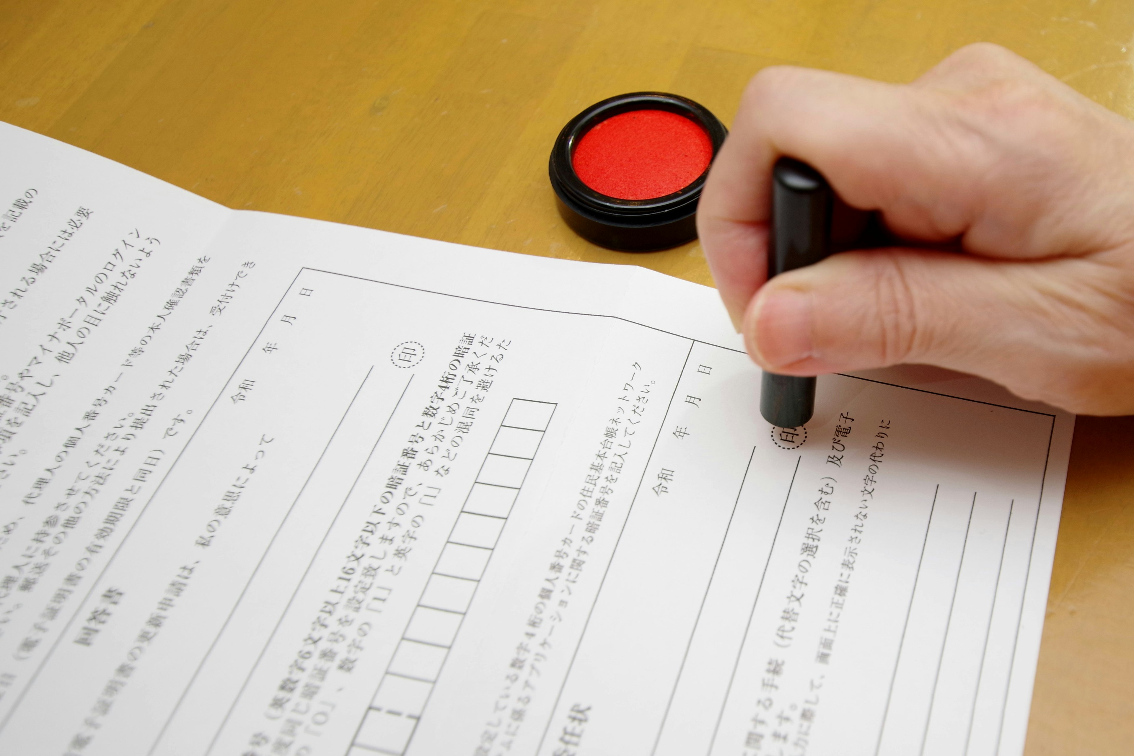 Hand writing on documents with a red stamp