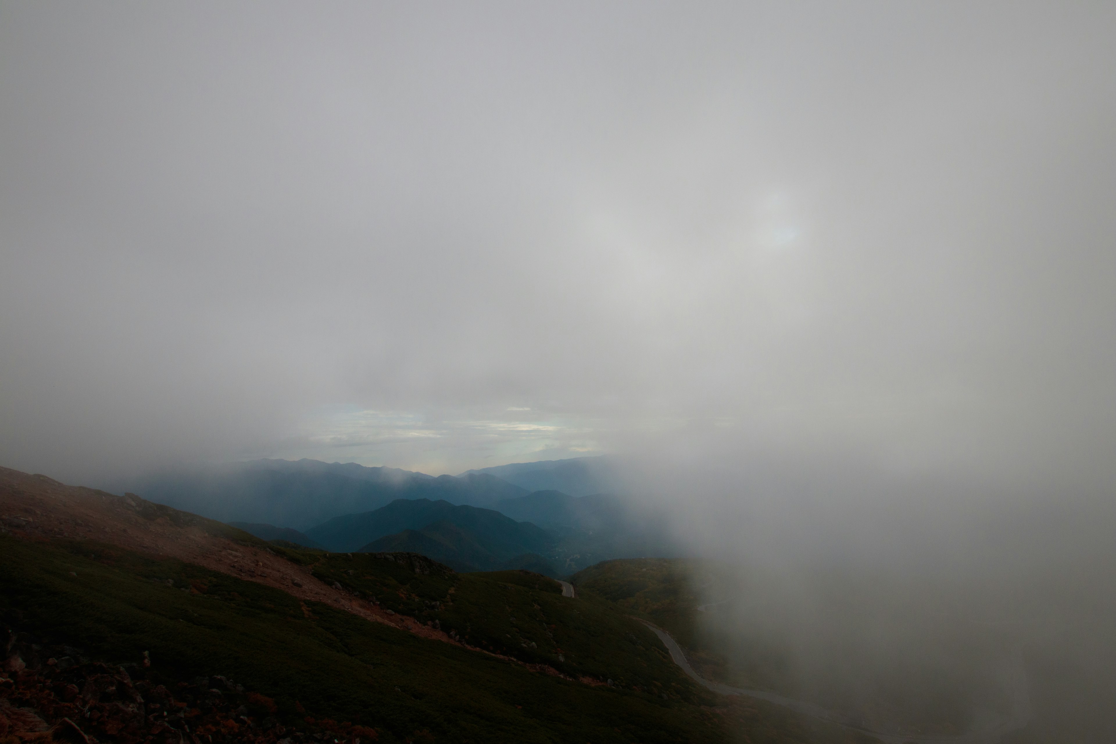 A misty mountain landscape shrouded in fog