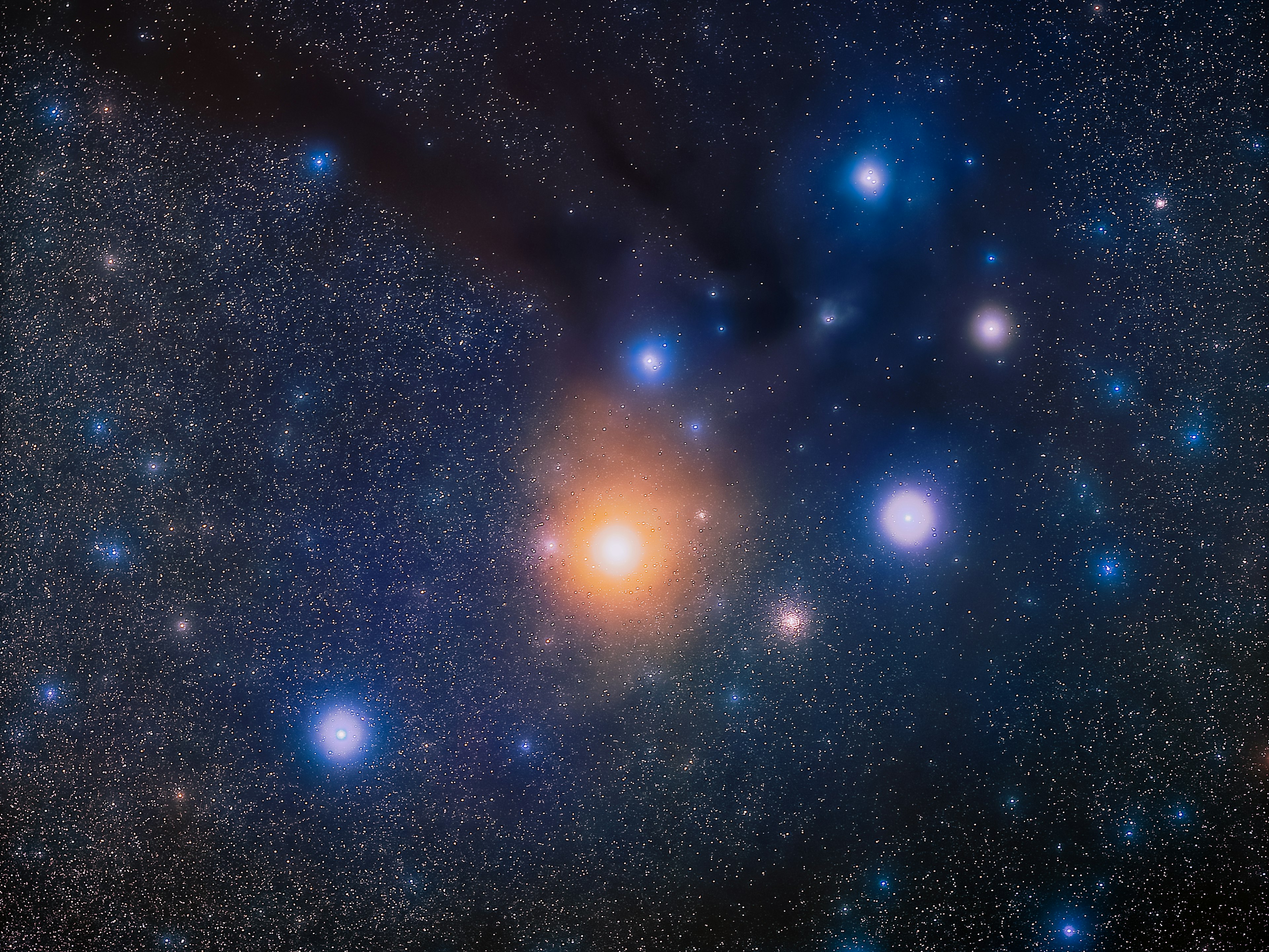 Imagen de un cielo estrellado con una brillante estrella naranja y varias estrellas azules