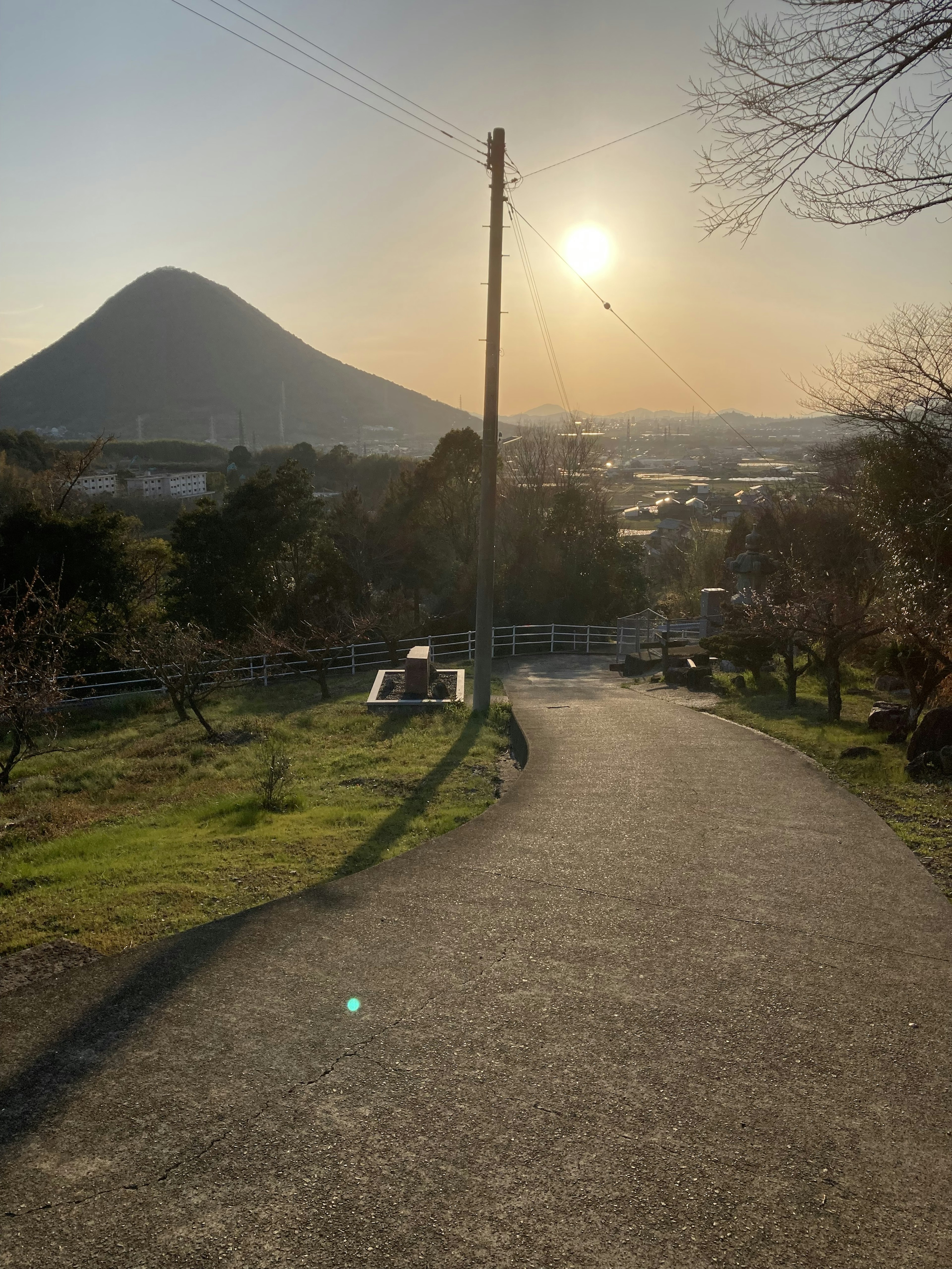 Scenic pathway leading towards a mountain and sunset