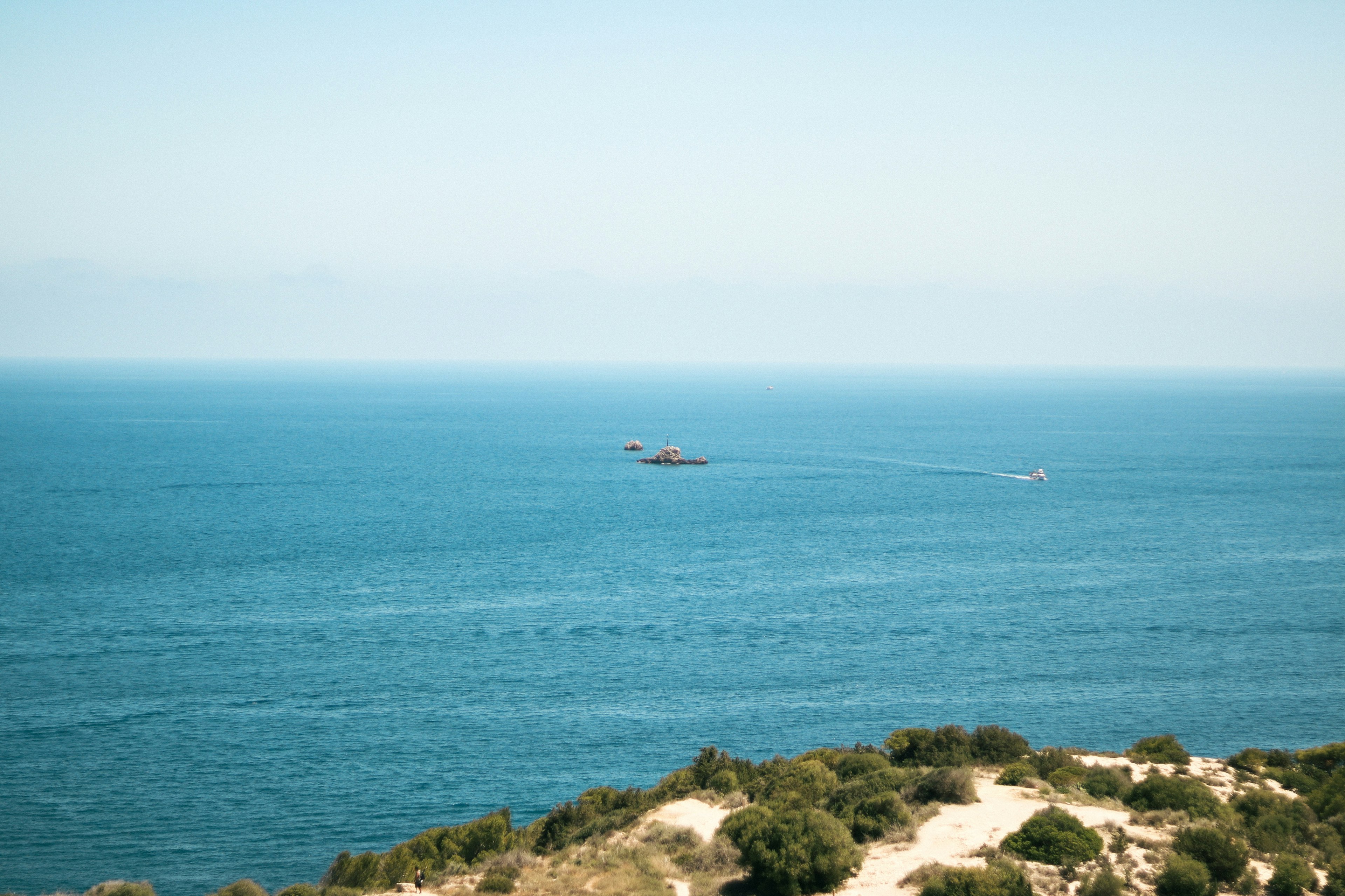 Scenic view of the blue ocean with a boat