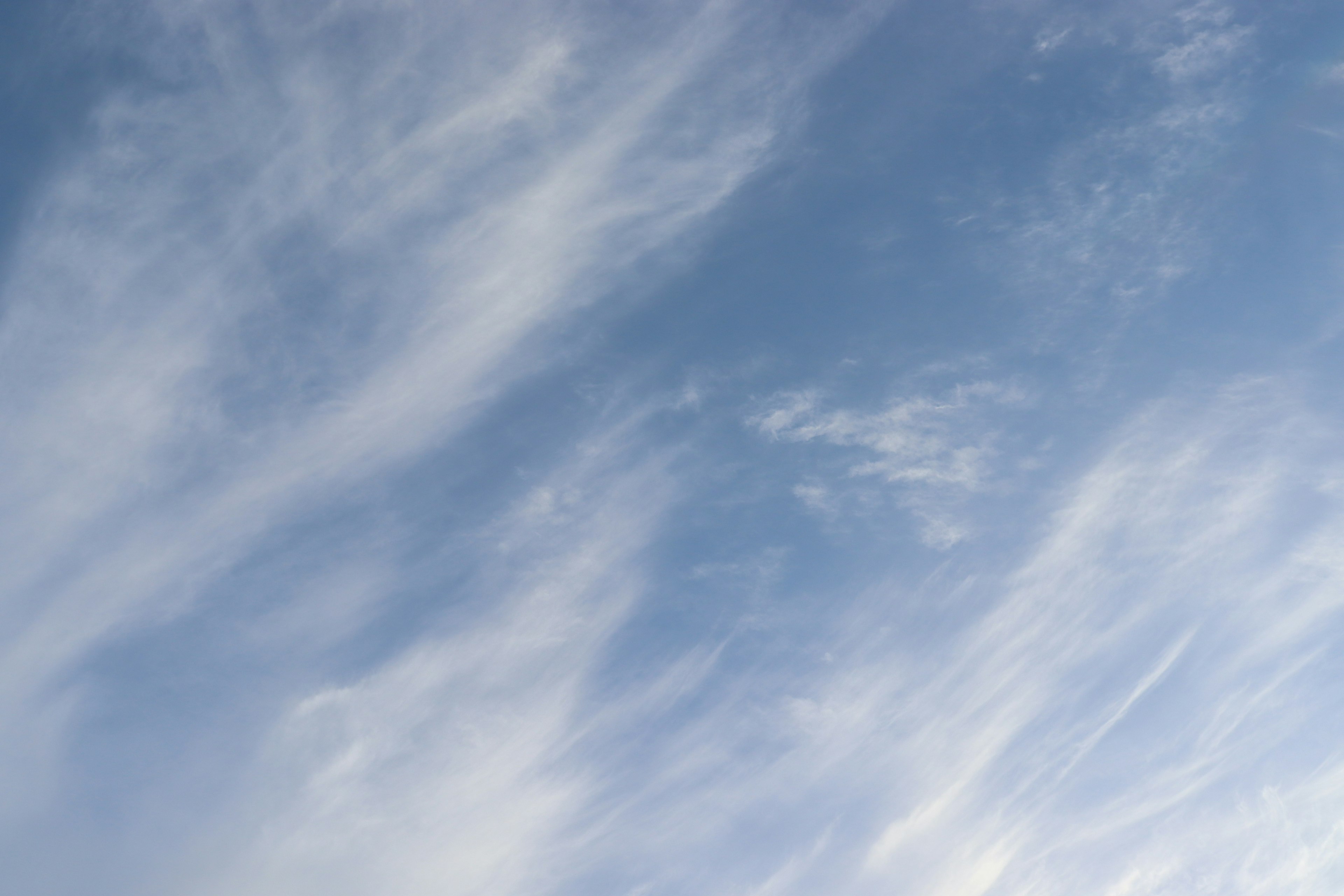 Pattern of wispy clouds in a blue sky