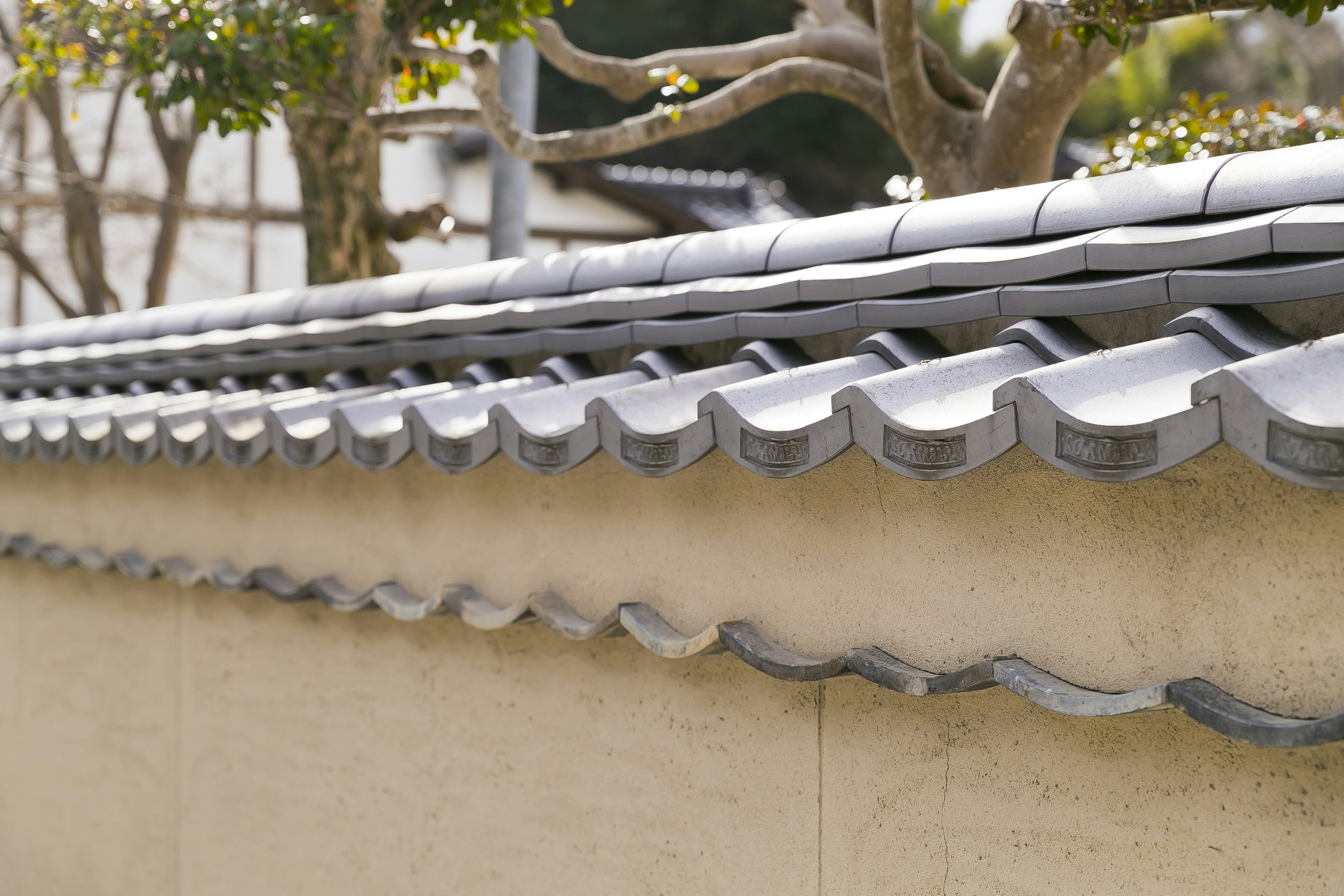 Close-up of a traditional tiled roof design on a wall