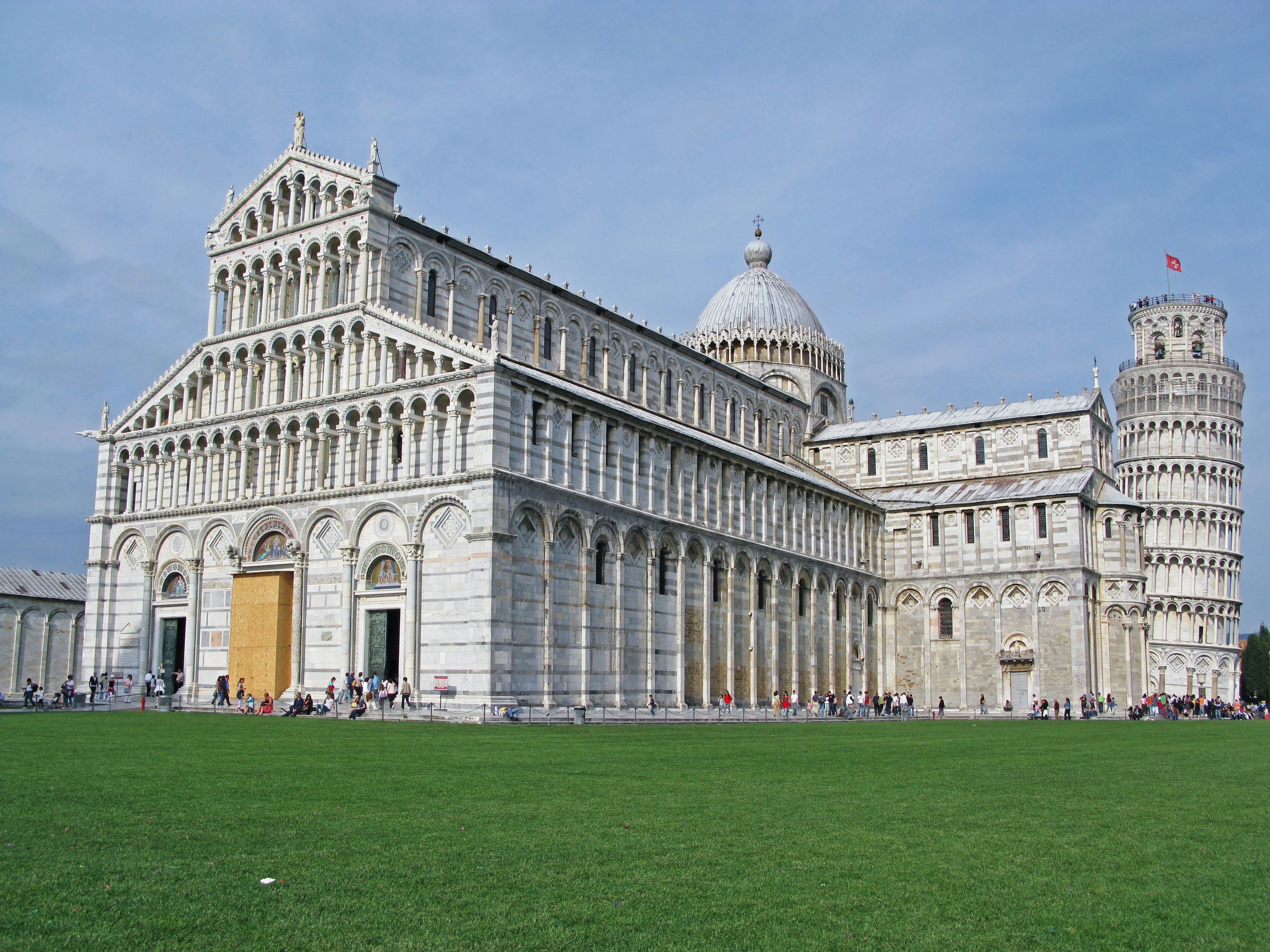 The magnificent architecture of the Leaning Tower of Pisa and the cathedral under a blue sky