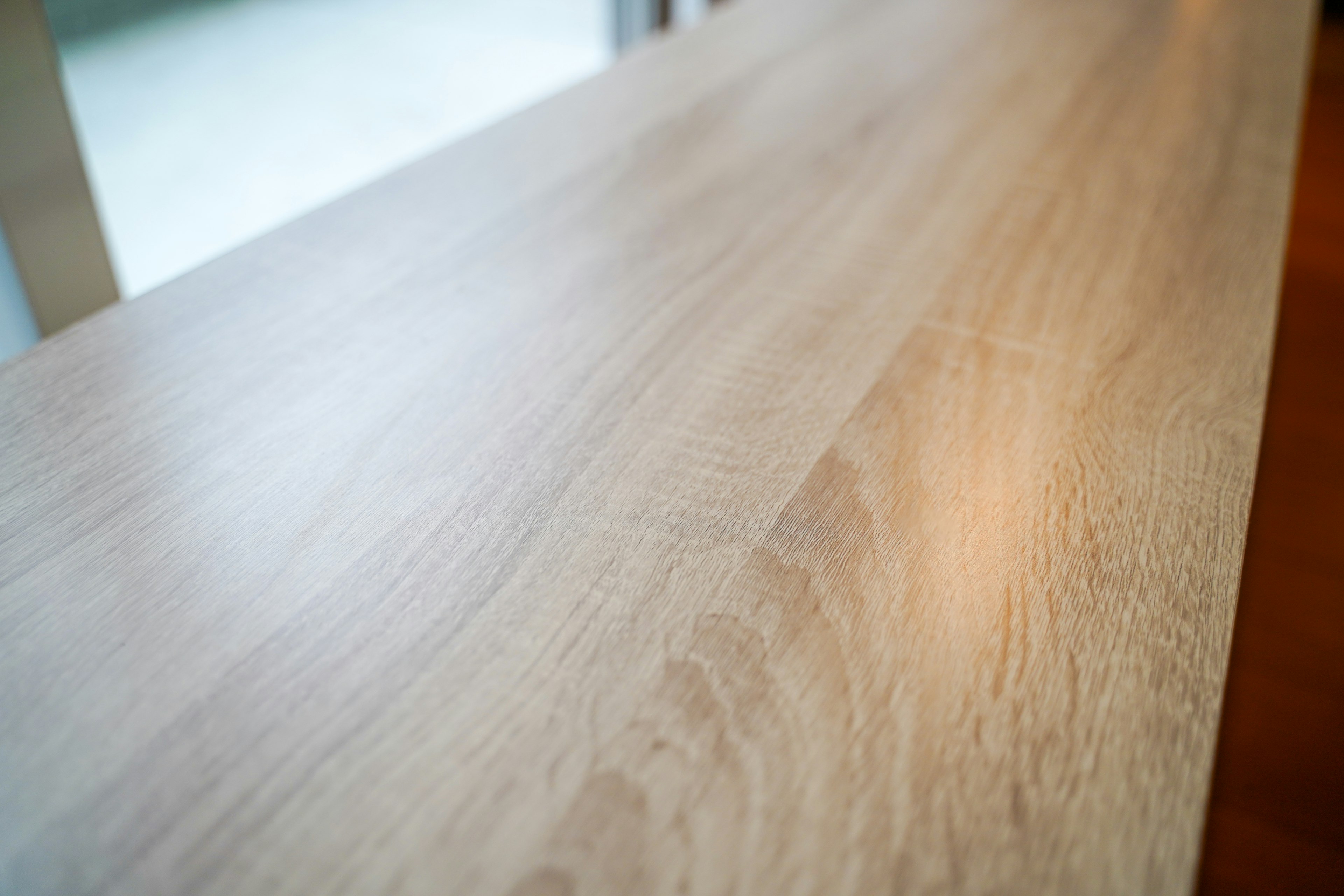 Smooth light-colored wooden table surface with visible grain