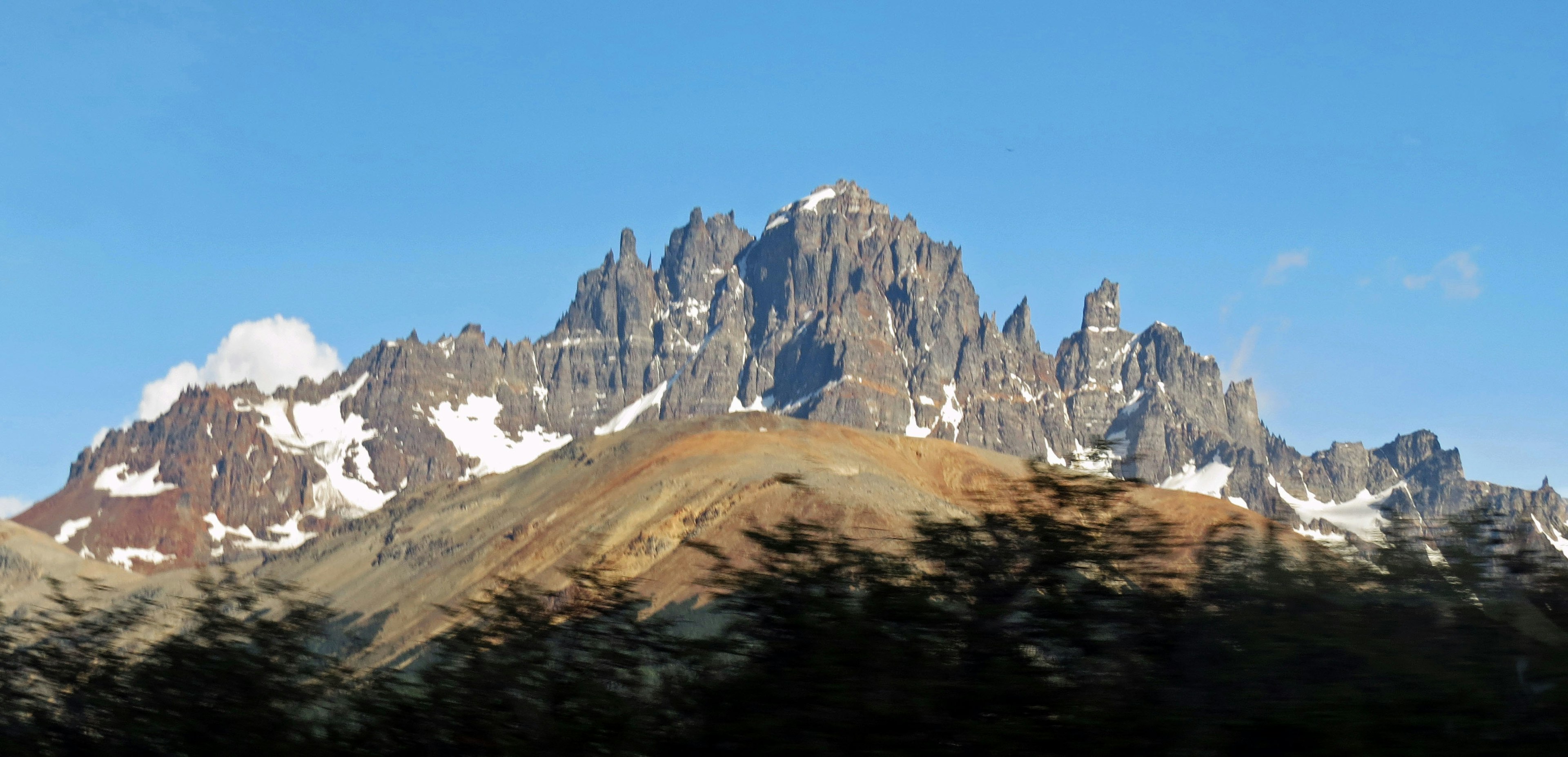 Snow-capped mountain peaks under a clear blue sky