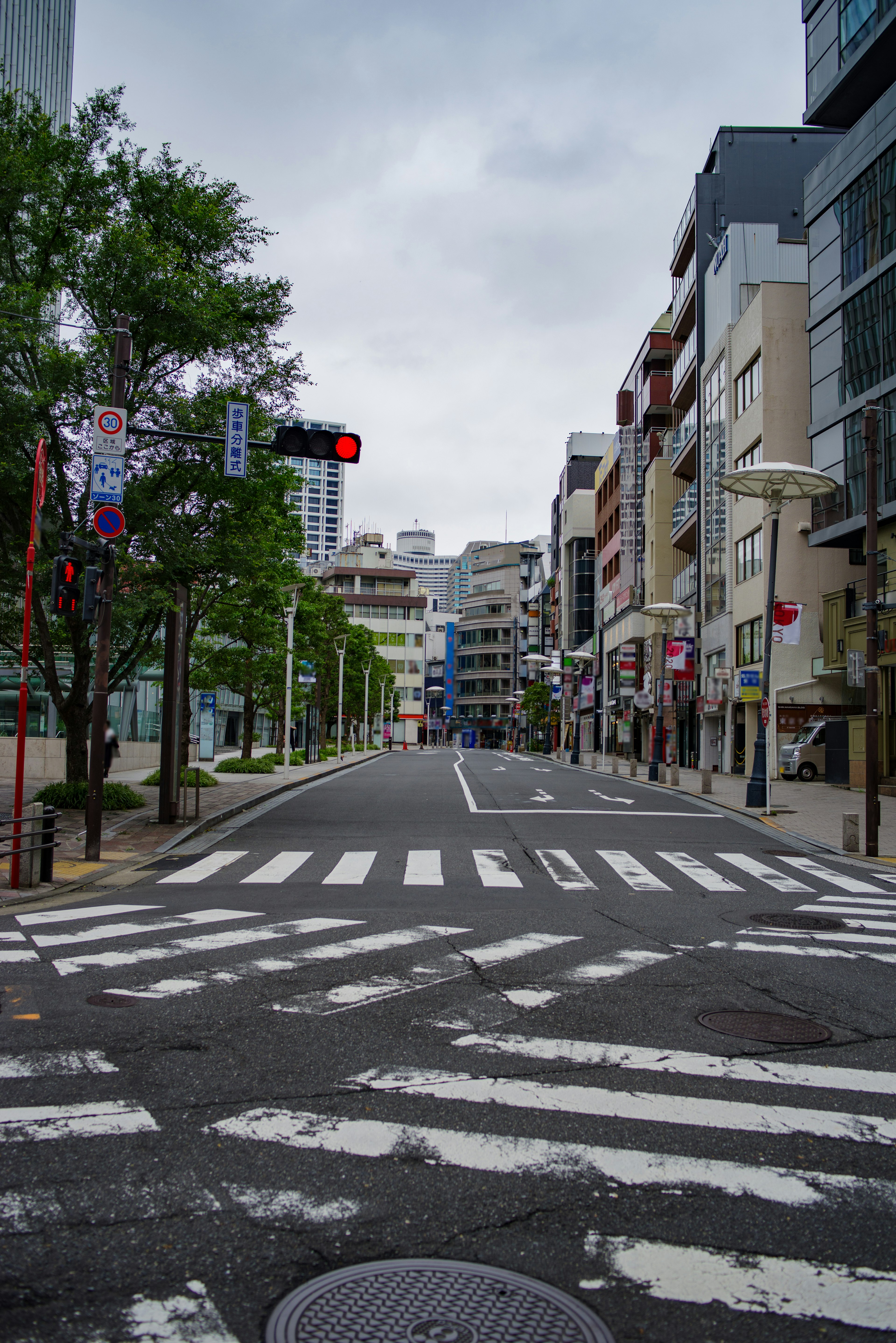 Quiet urban street view with a red traffic light