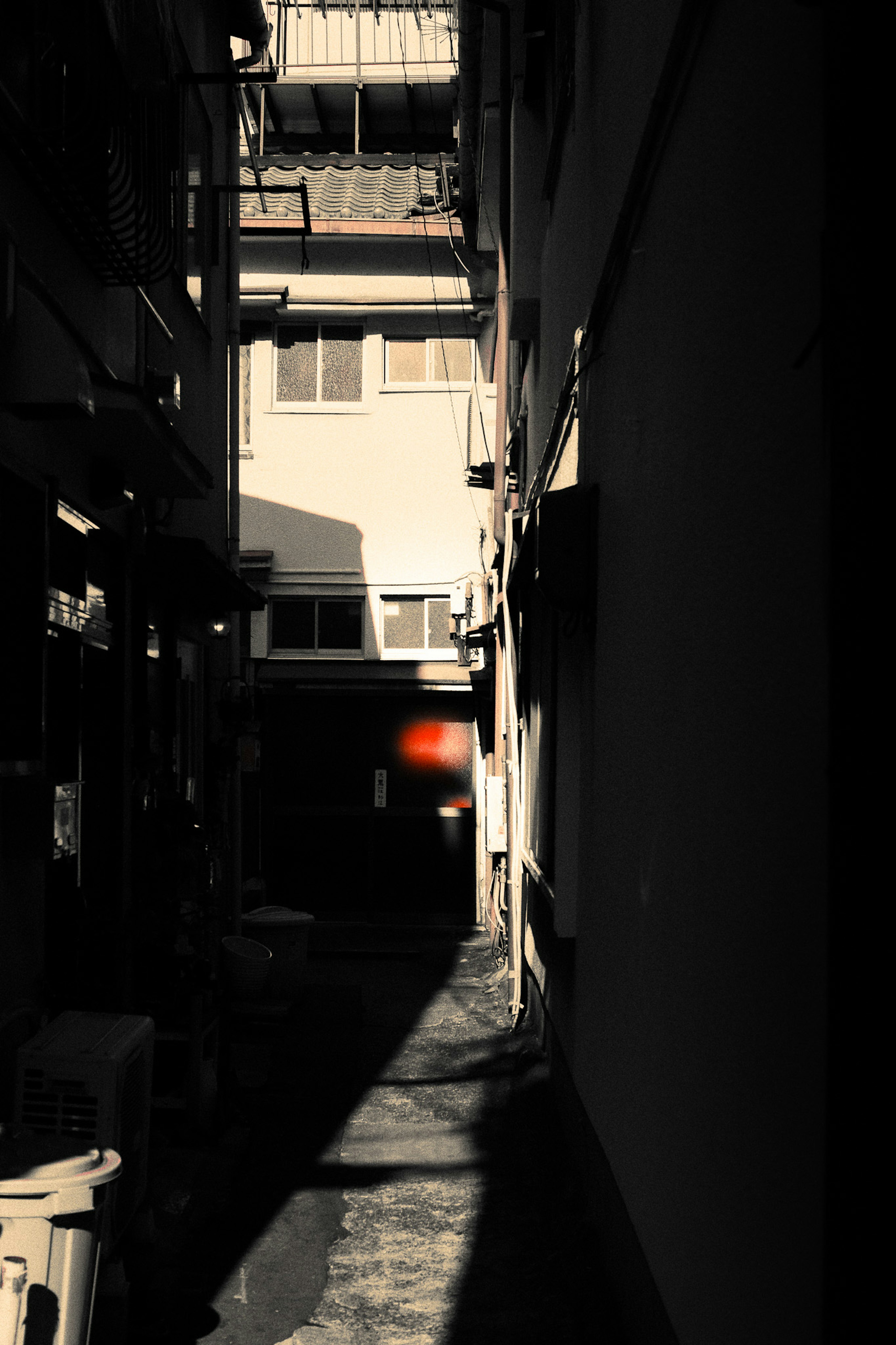 Narrow alley with contrasting light and shadows