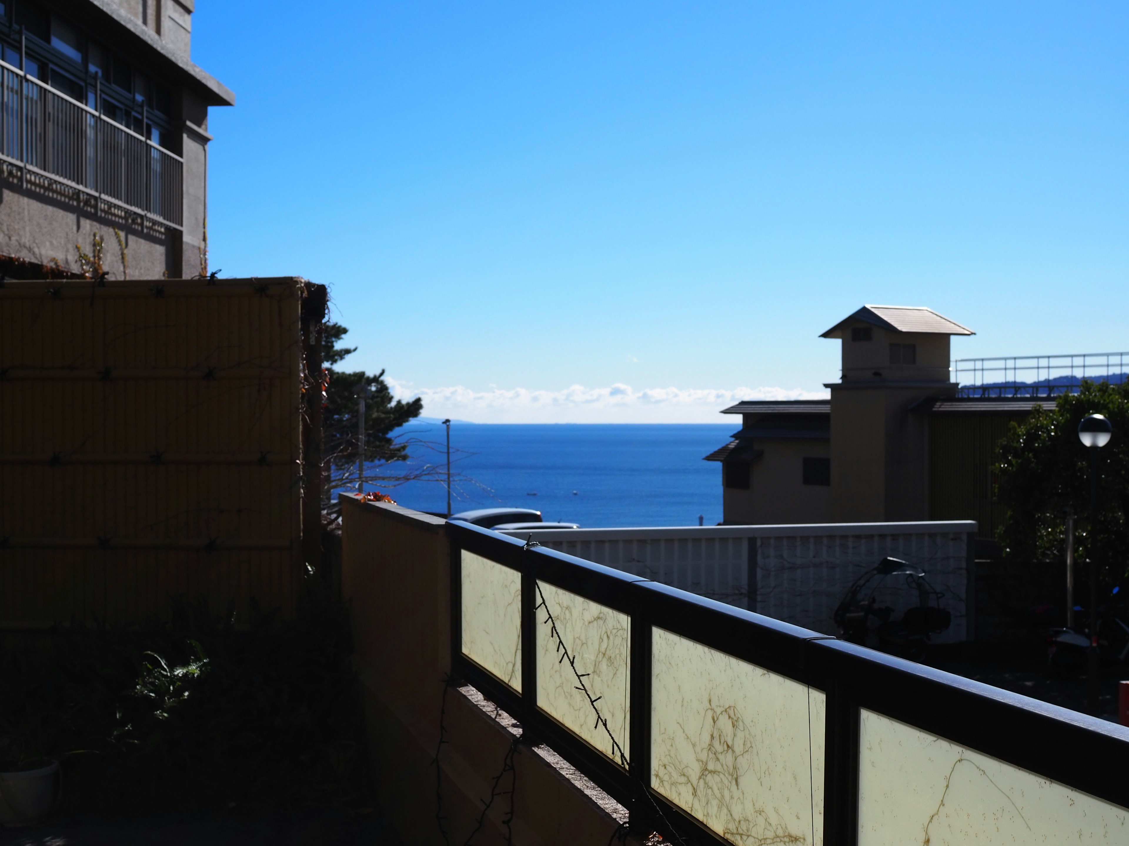 Balcony view overlooking the sea with clear blue sky