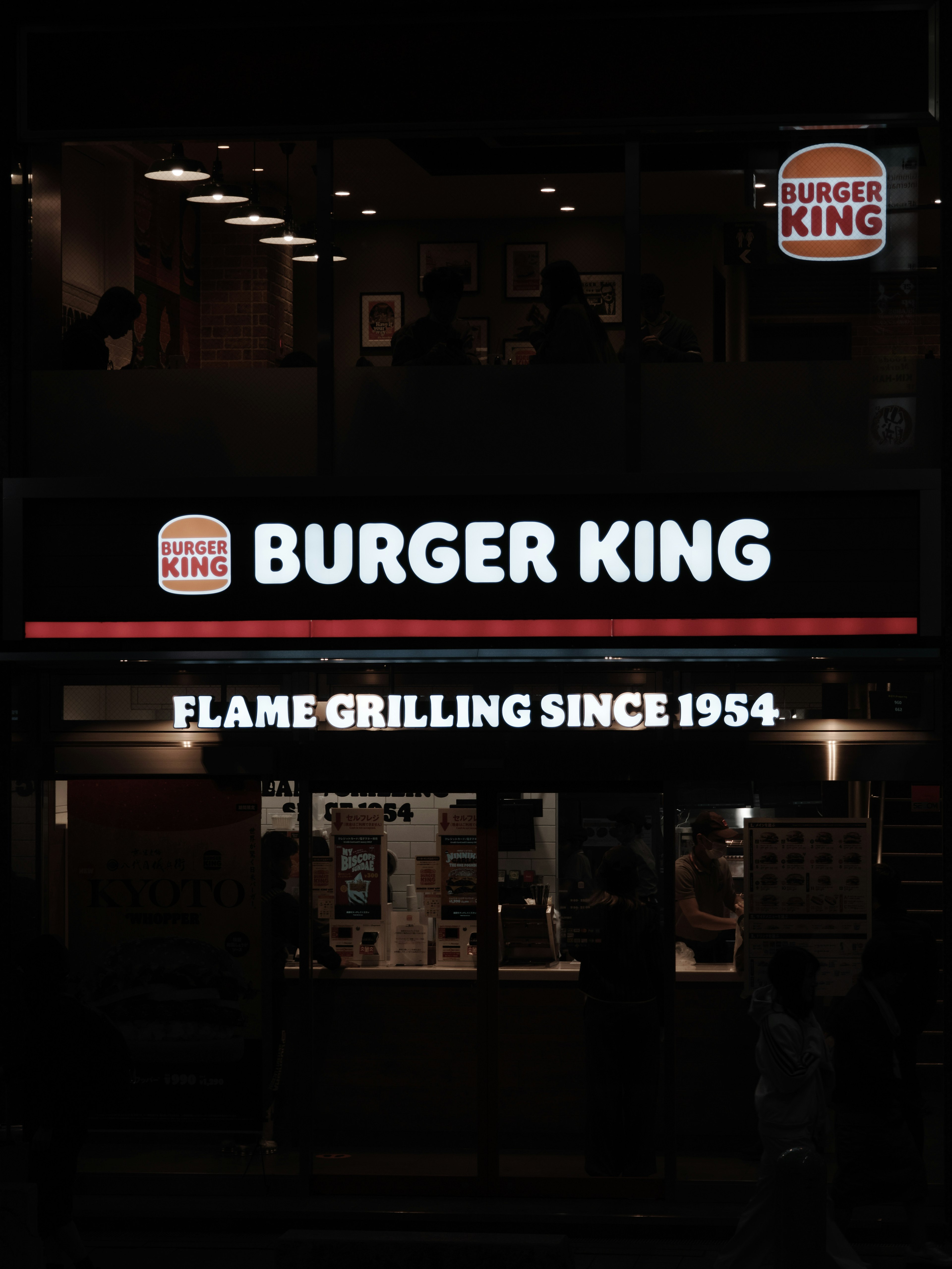 Illuminated Burger King sign at night