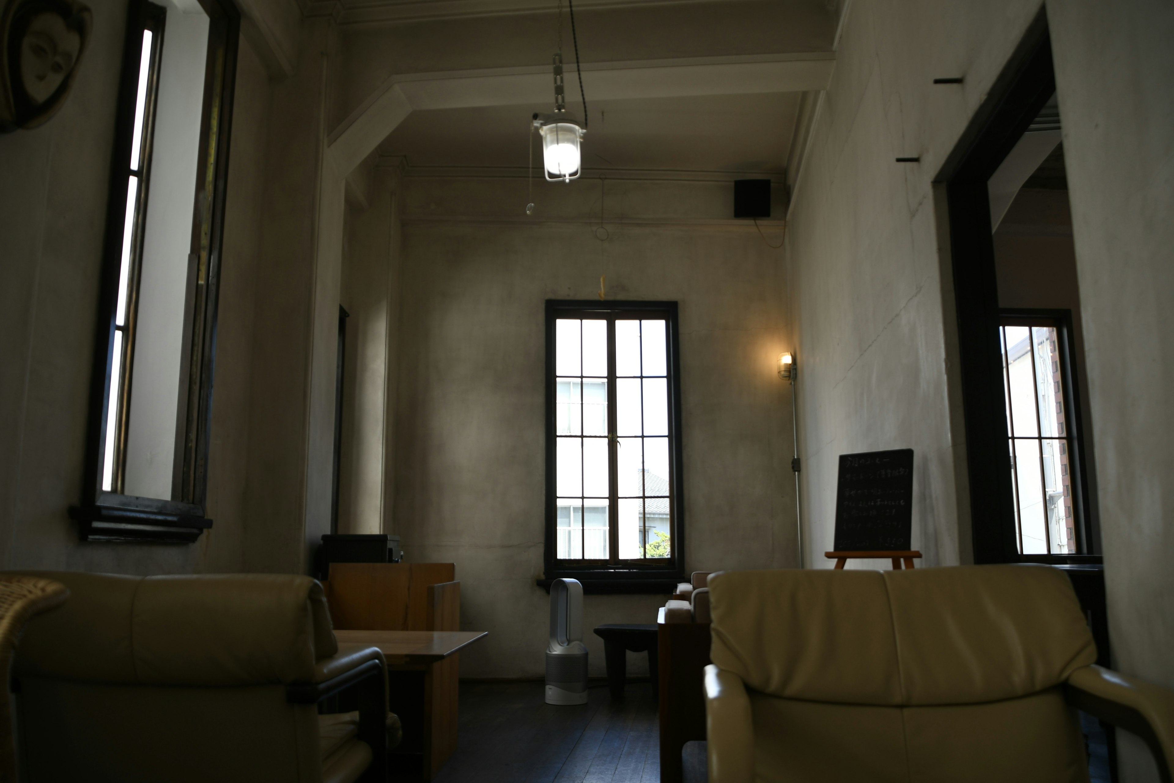 Einfaches und beruhigendes Café-Interieur mit natürlichem Licht, das durch die Fenster strömt