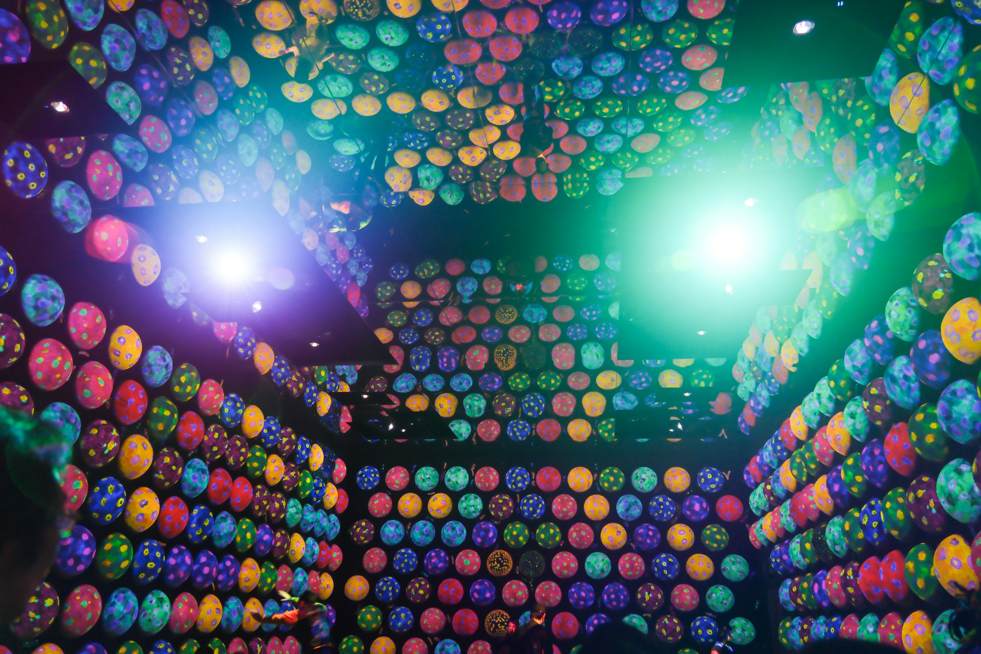 Room covered with colorful spheres and bright lighting effects