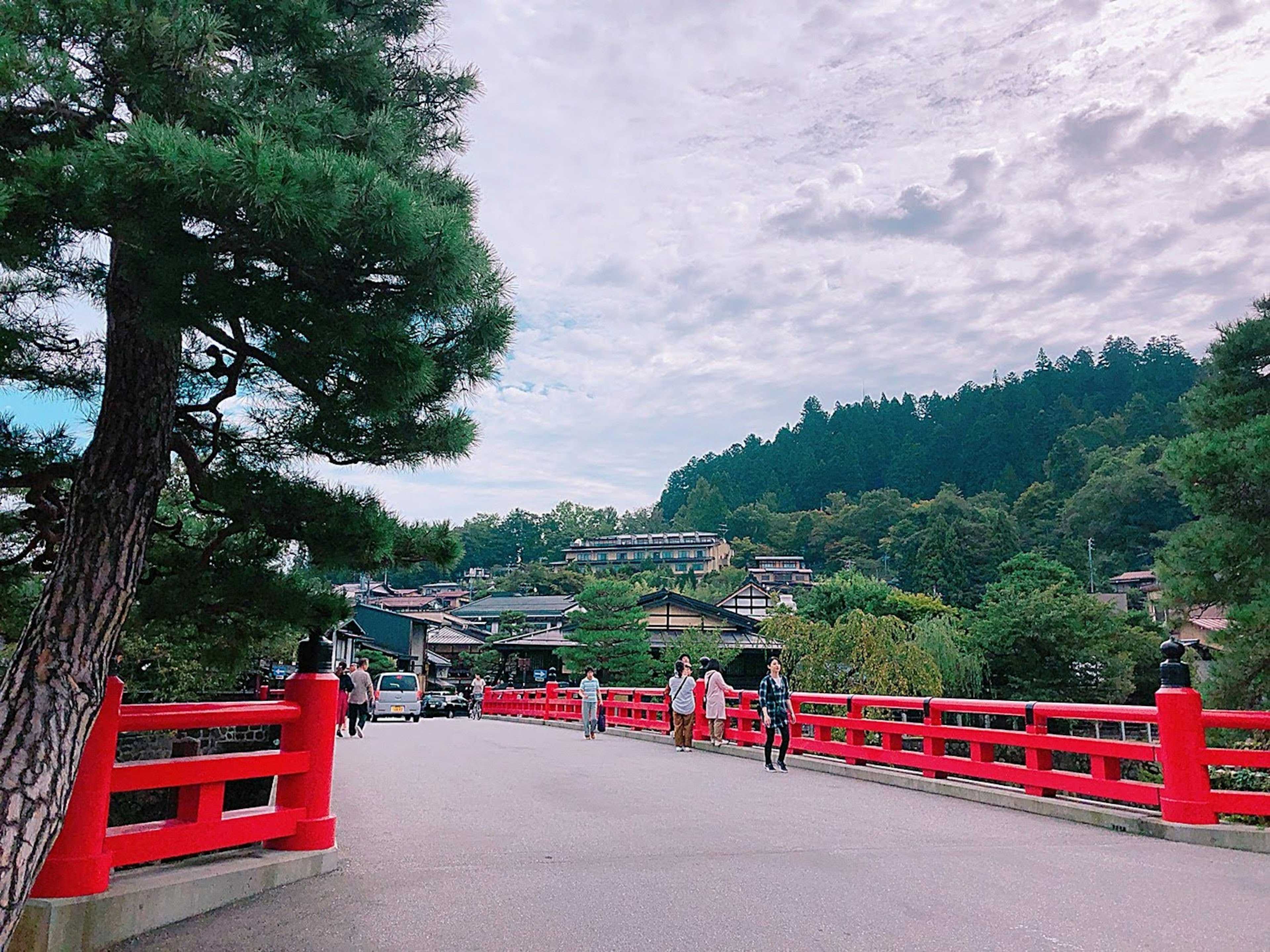 Scenic view of a red bridge with green hills in the background