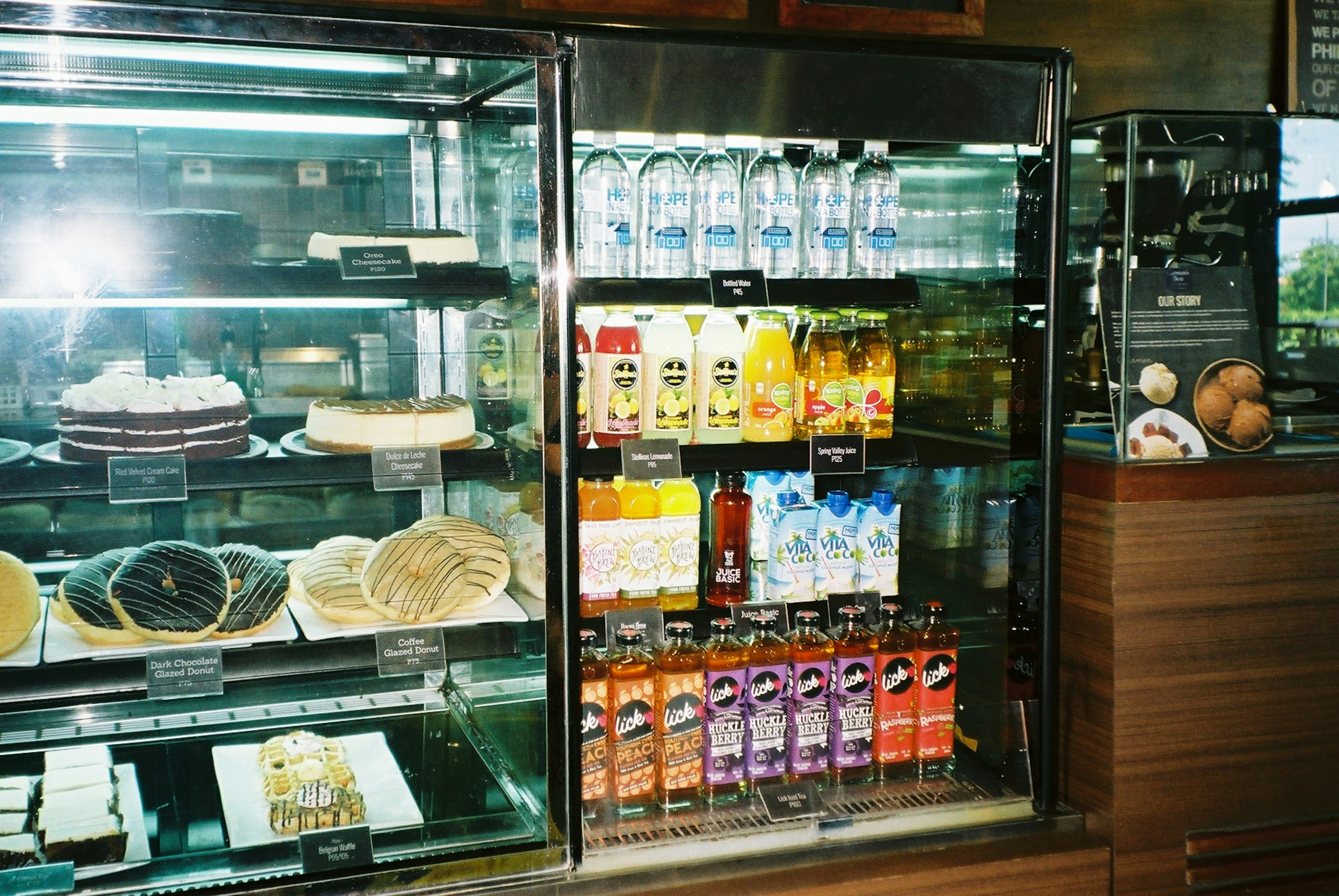 Display case filled with cakes and beverages