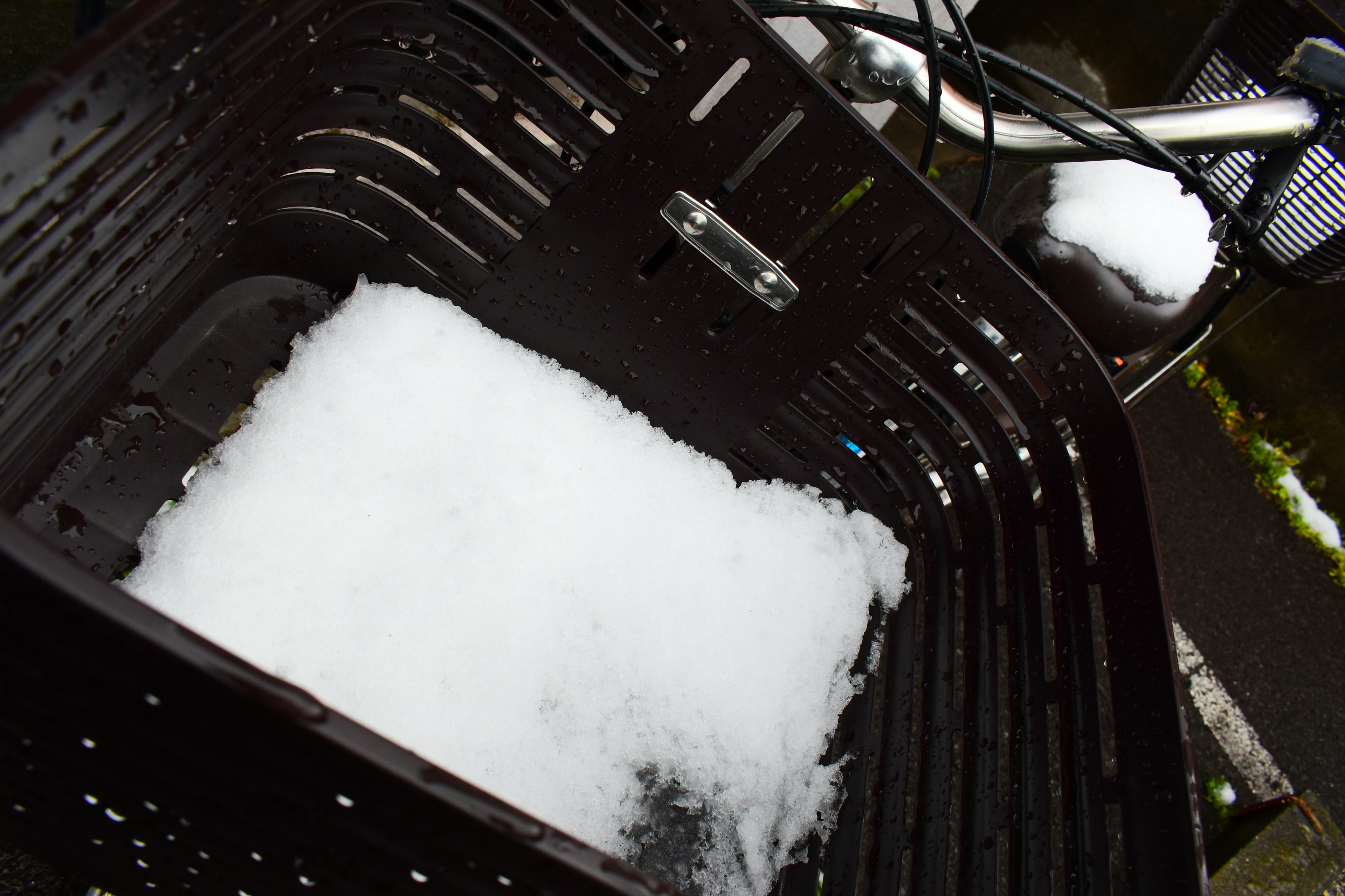 Snow piled in a bicycle basket