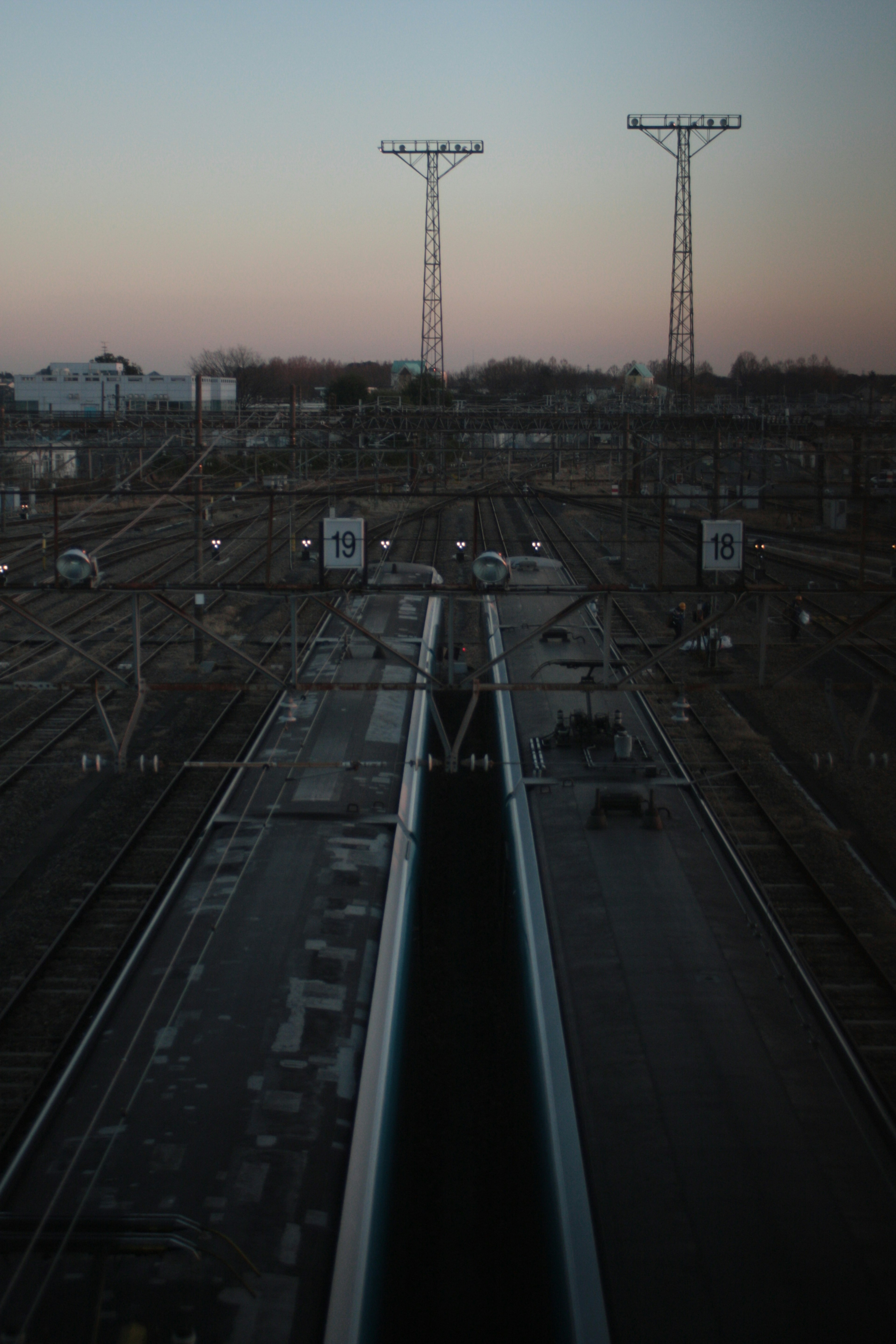 Evening train yard scene with overhead power lines