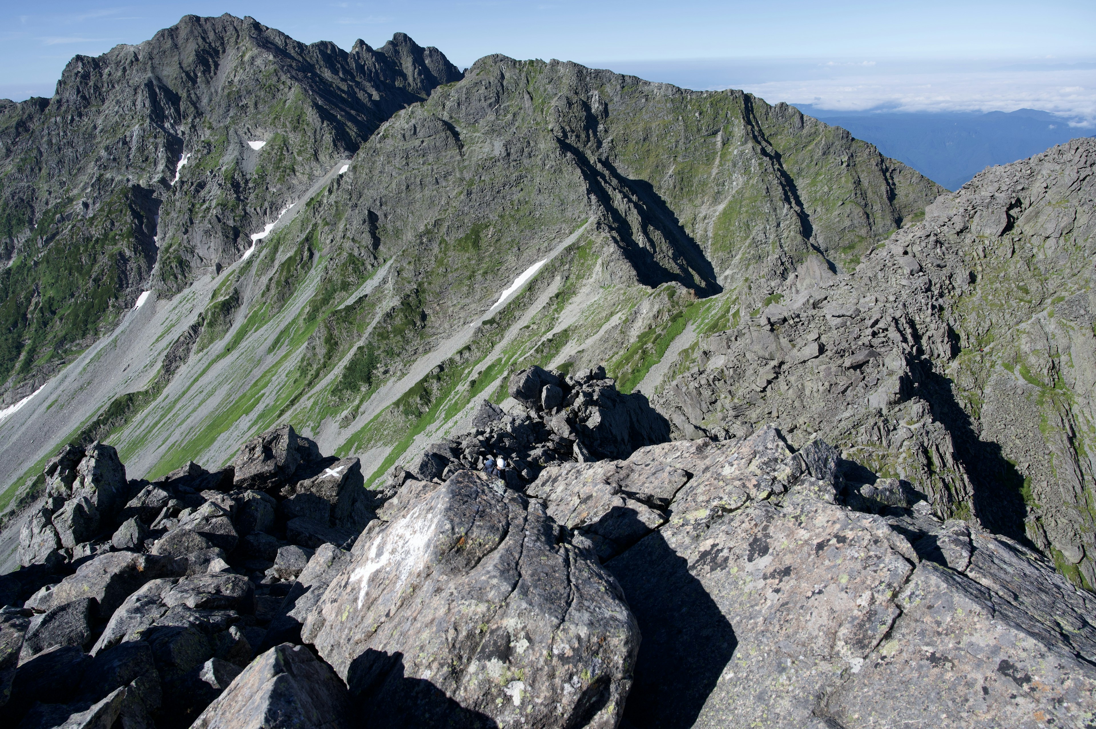 Stunning mountain view from the summit rocky terrain and green slopes