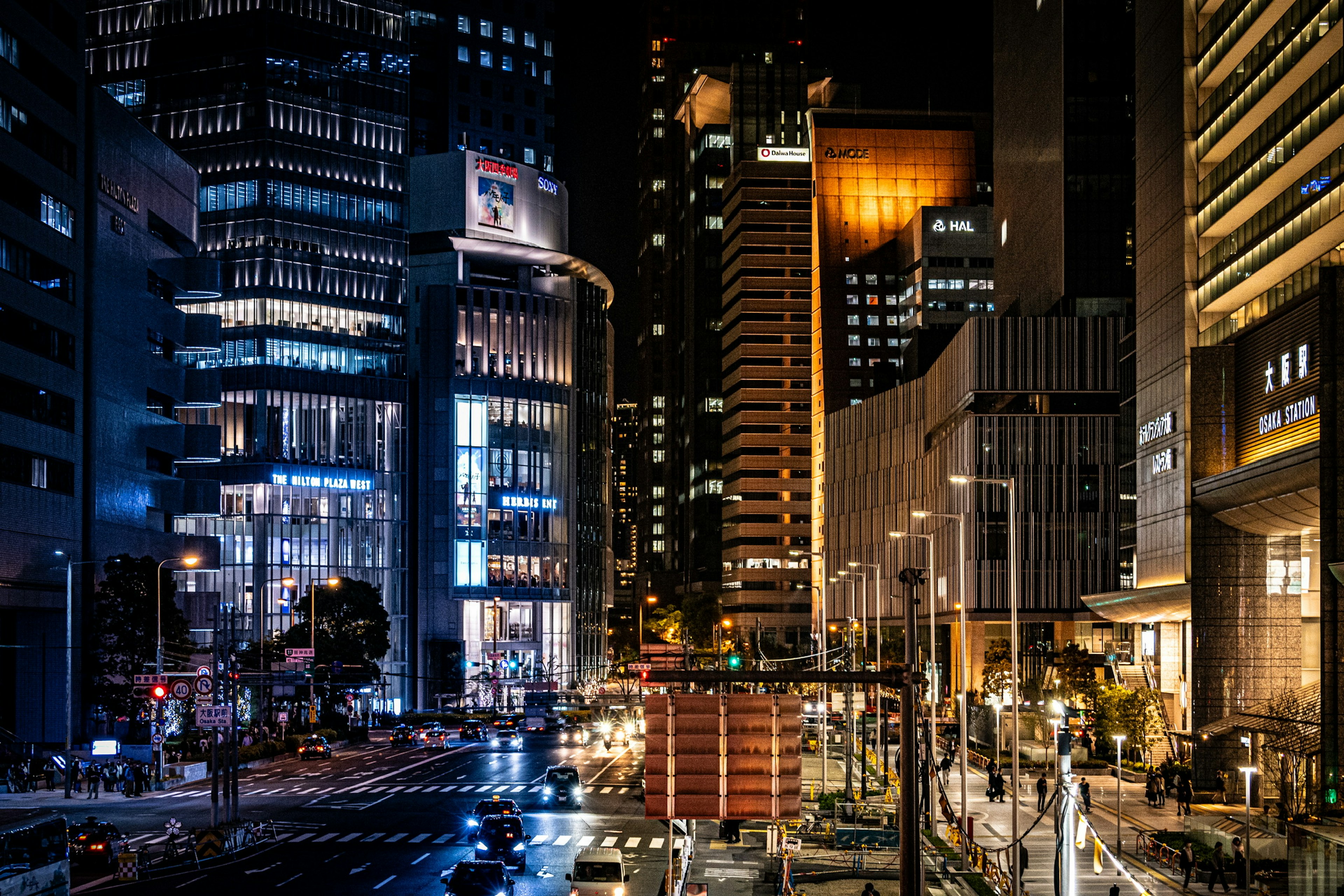 Night cityscape featuring tall buildings and bright lights