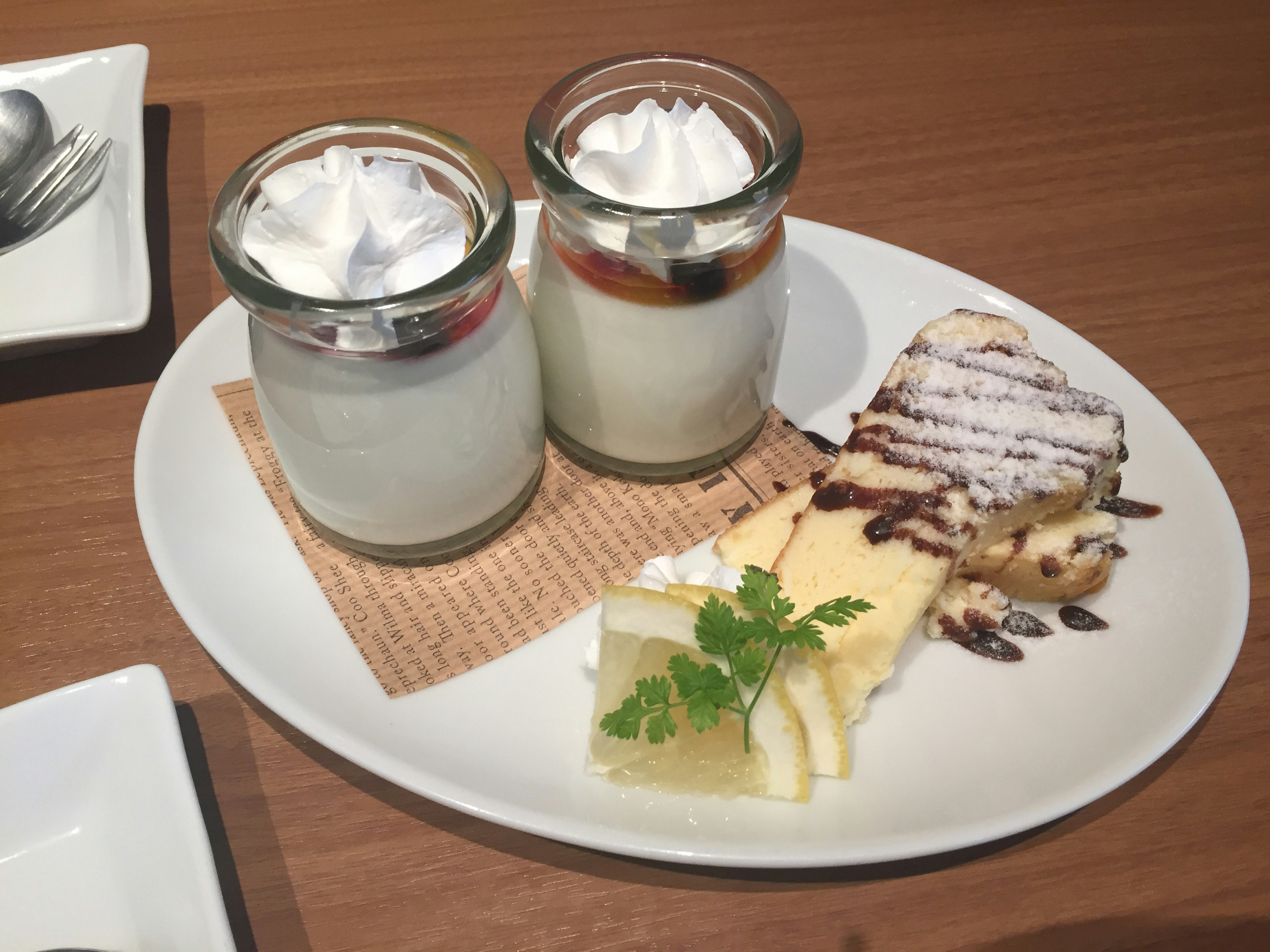 Two dessert cups and a slice of cake on a plate