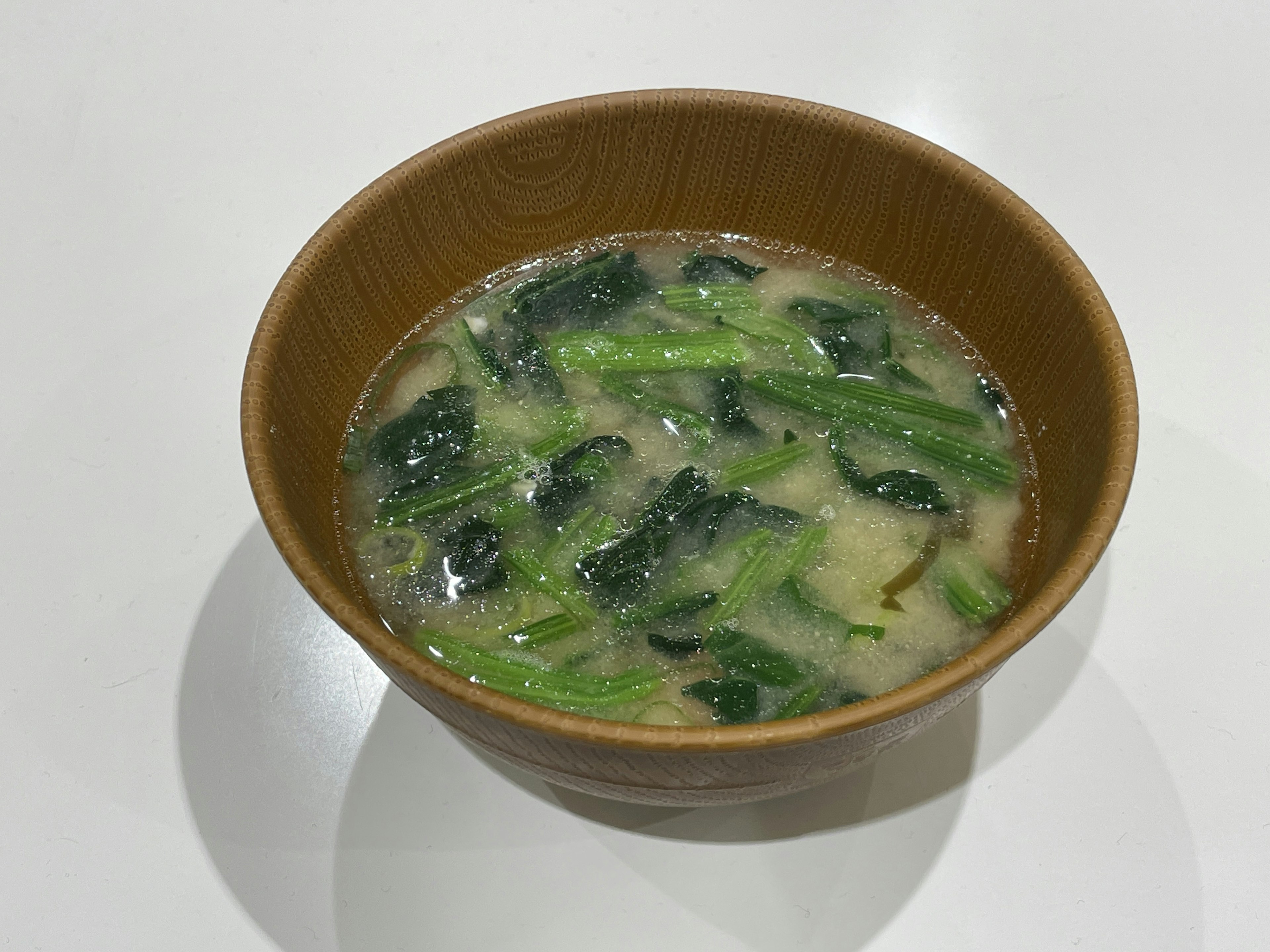 Bowl of soup with green vegetables