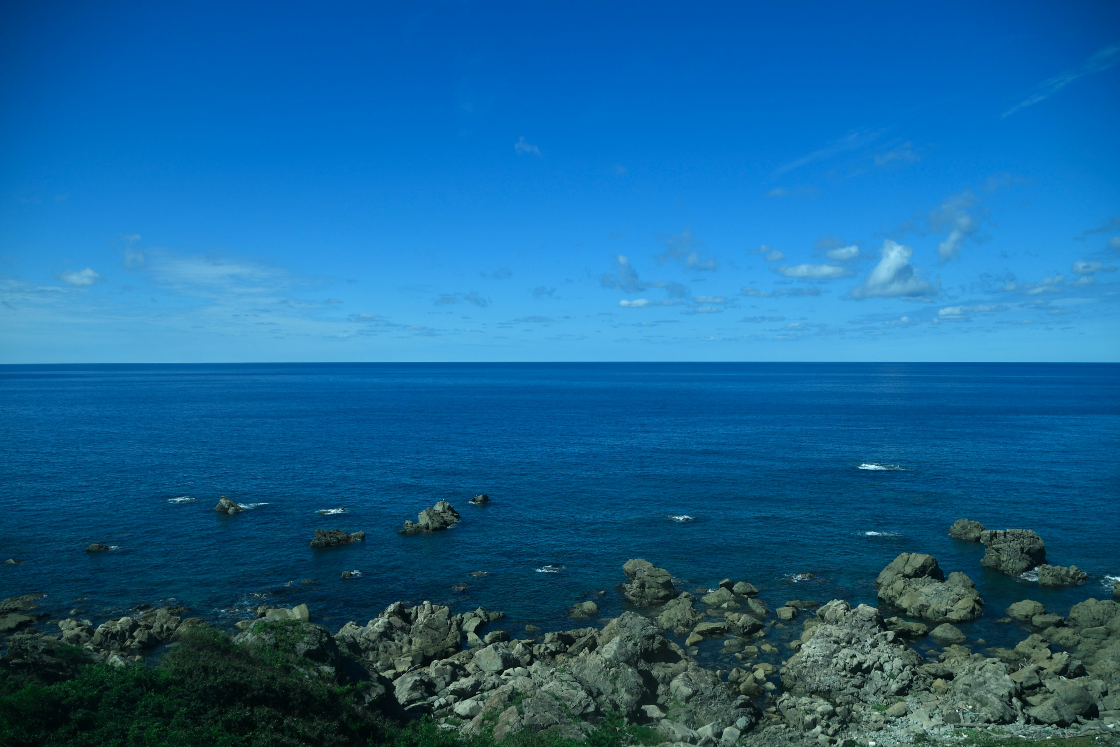 Beautiful blue ocean view with rocky shoreline