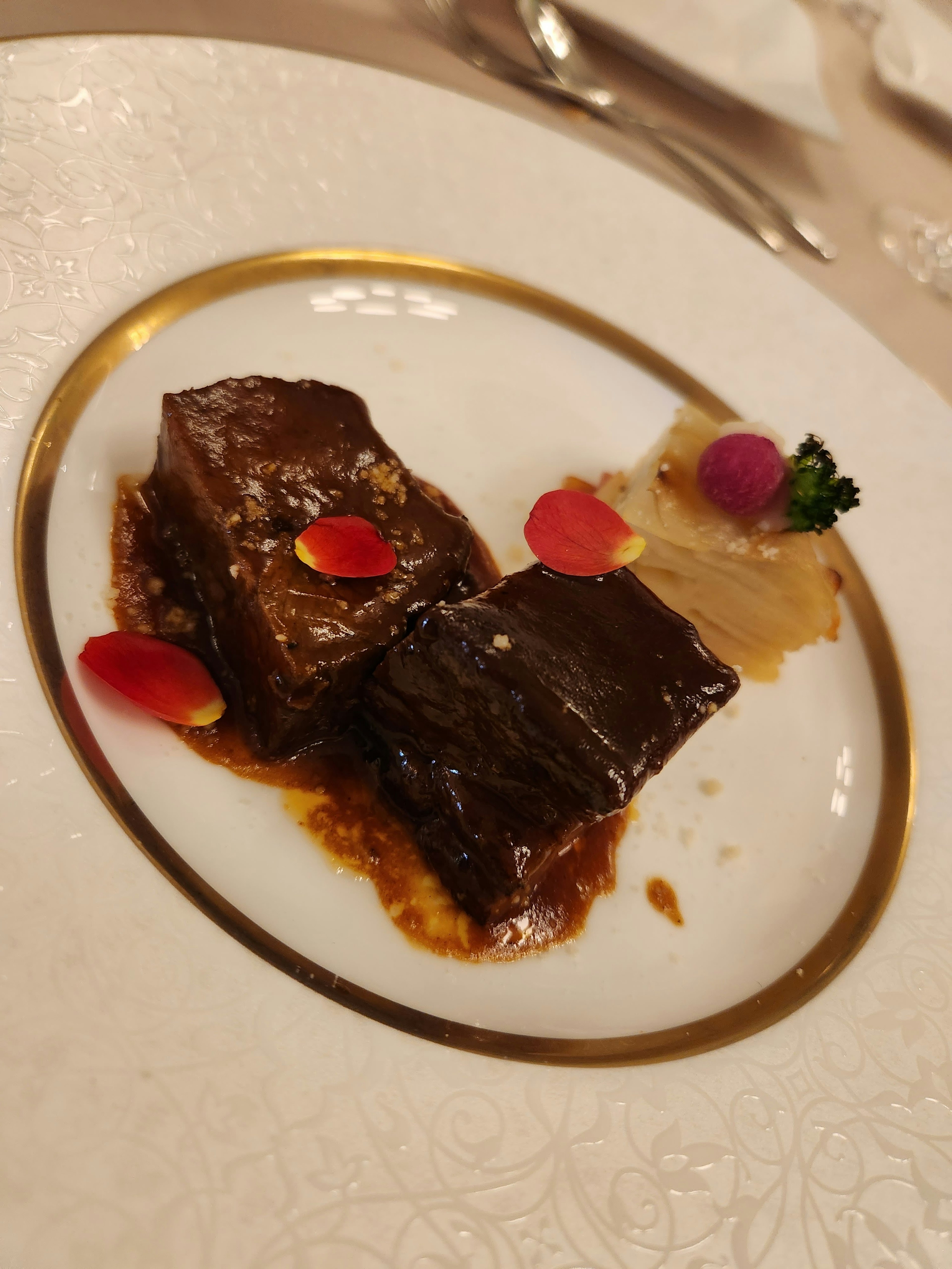 Elegant plate featuring tender meat dish with decorative vegetables