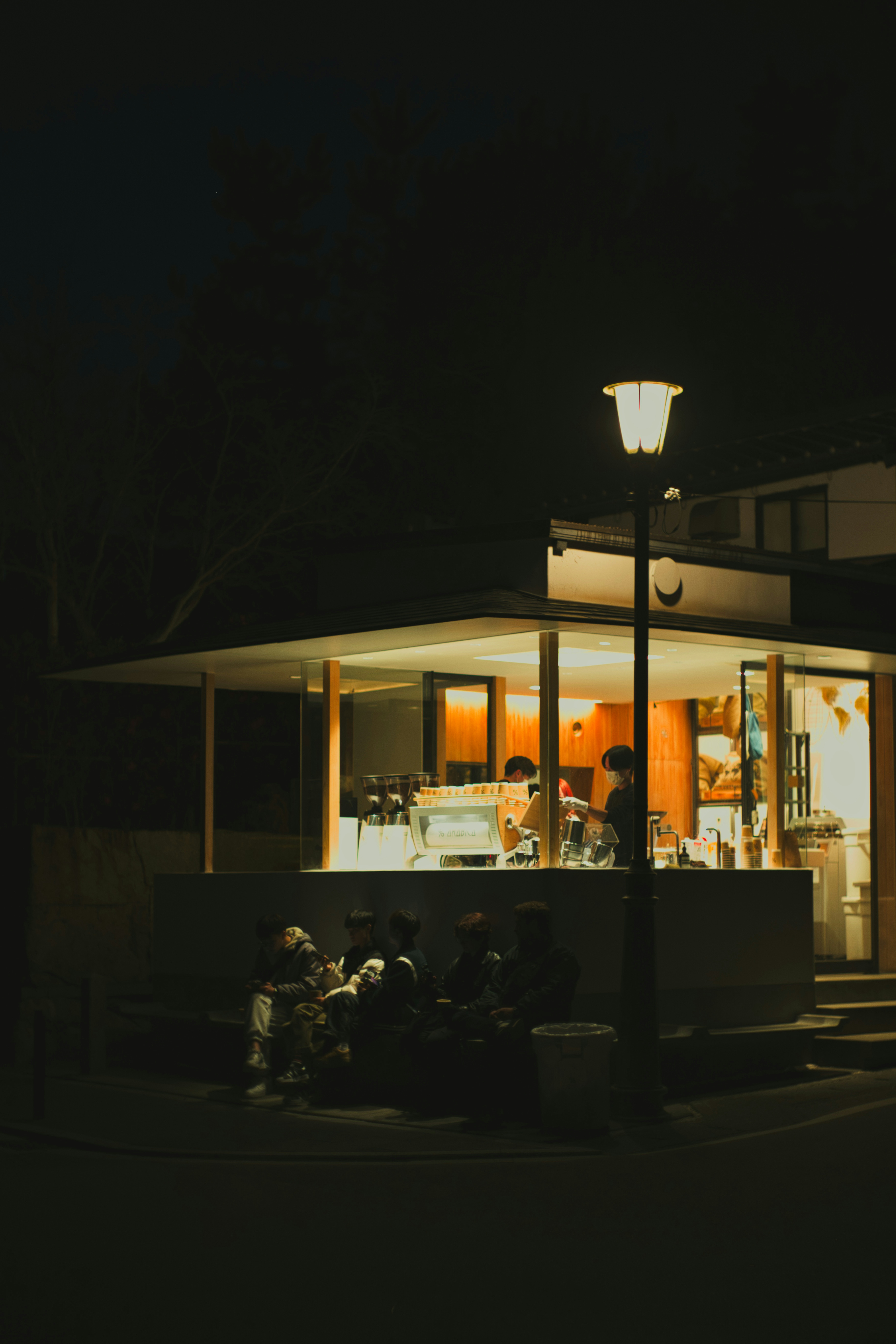 Extérieur d'un café la nuit avec un éclairage chaleureux