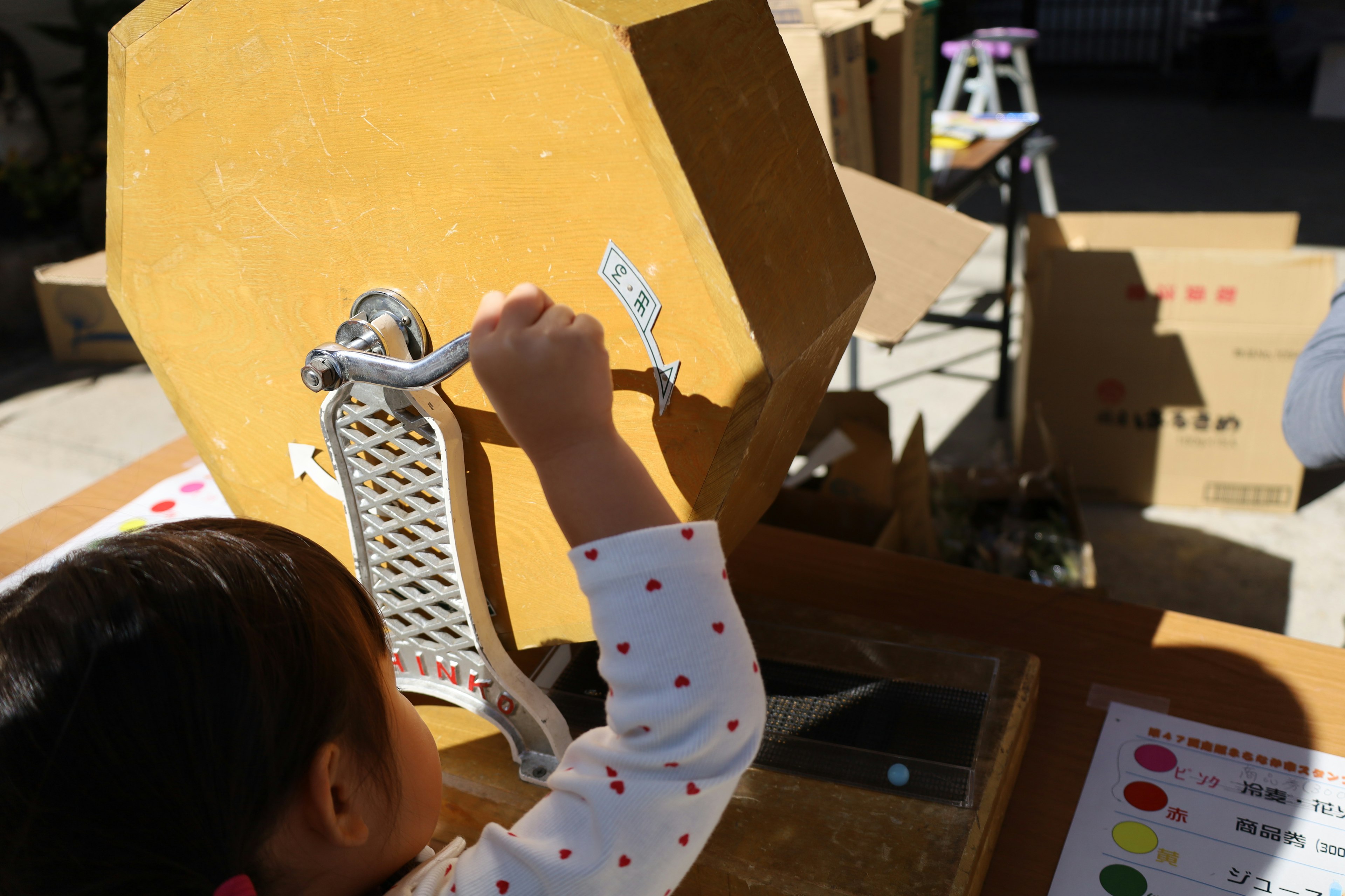 A child operating a lottery wheel