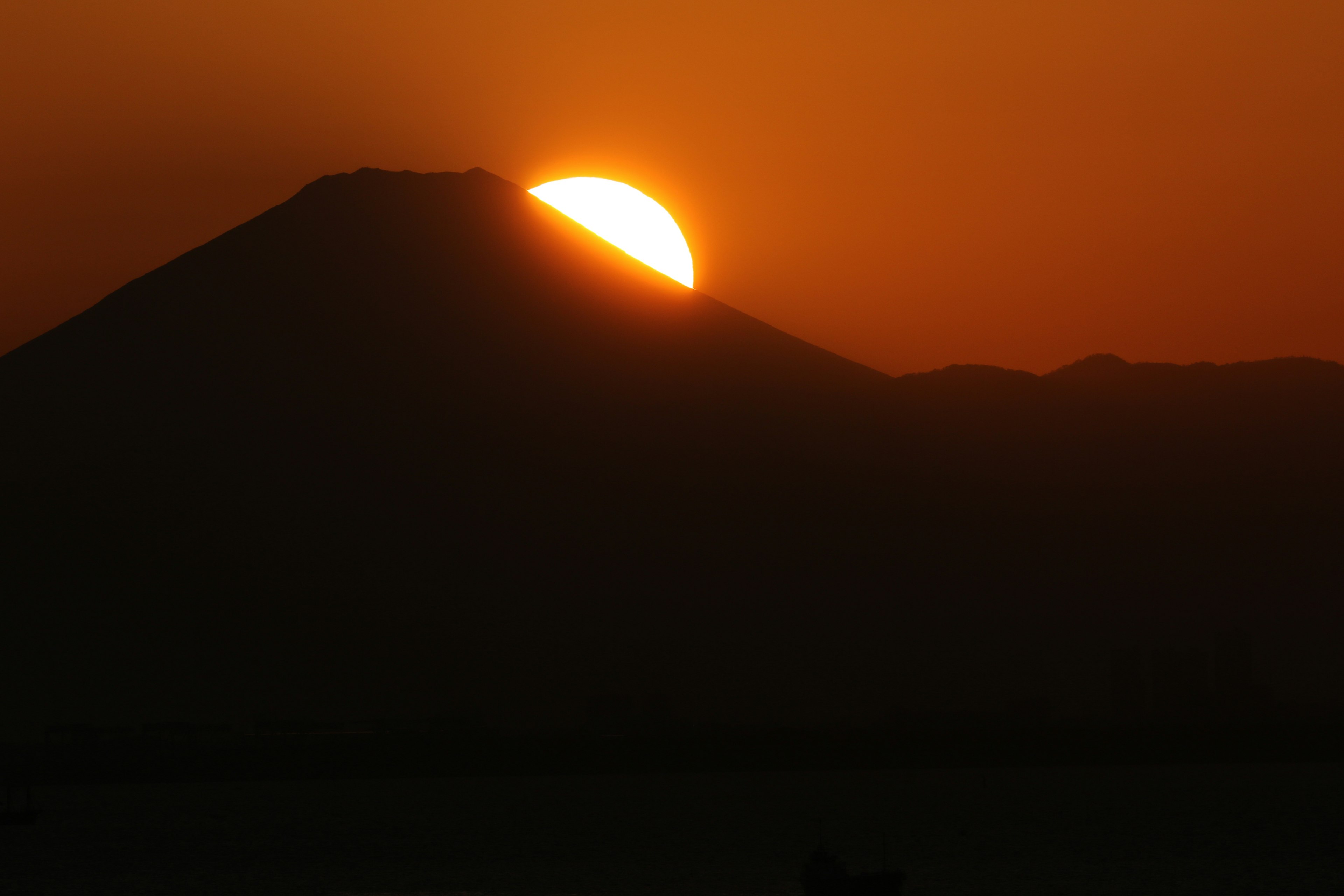 Beautiful landscape with the sun setting behind a mountain