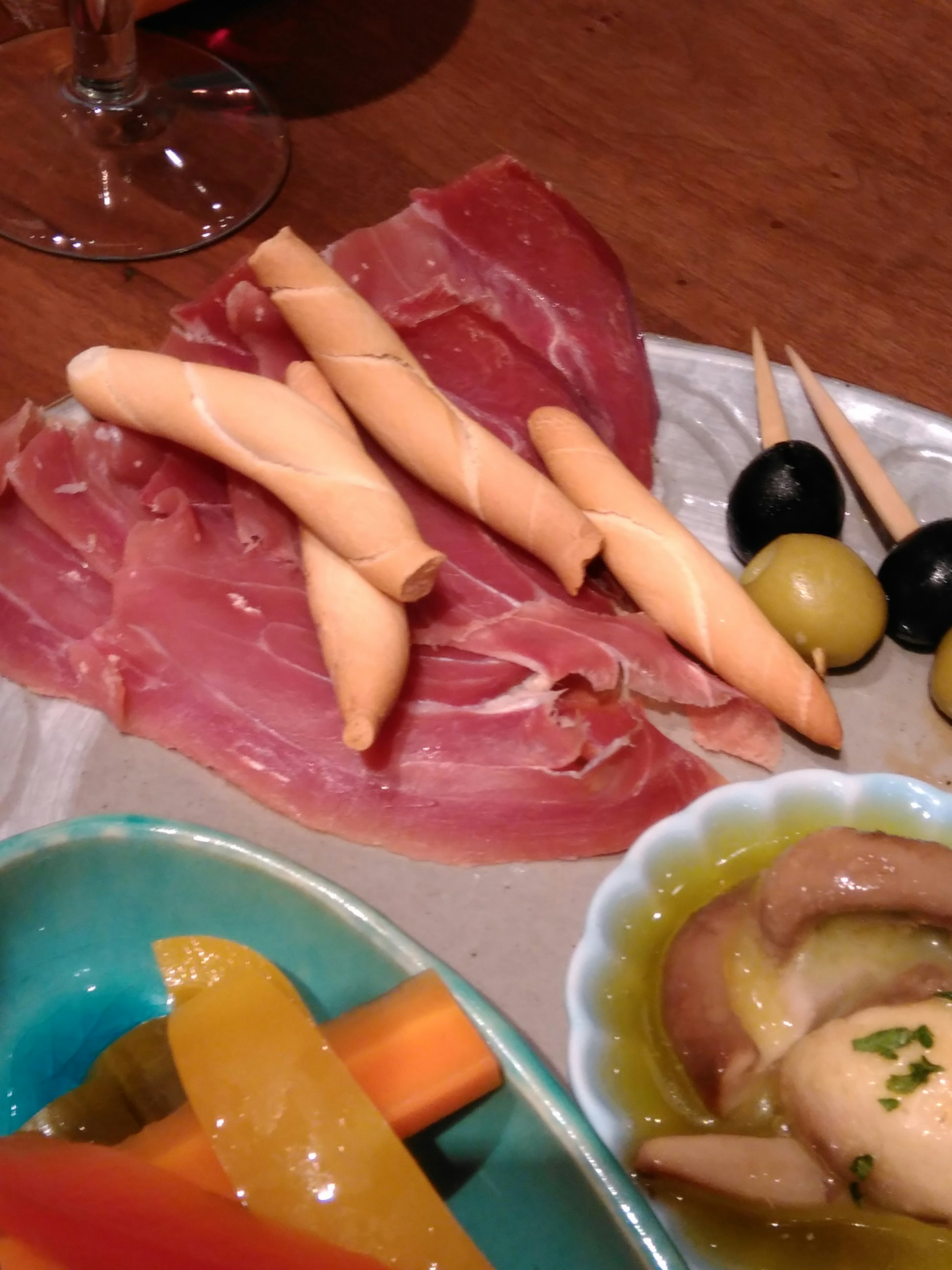 A platter featuring colorful vegetables and slices of ham