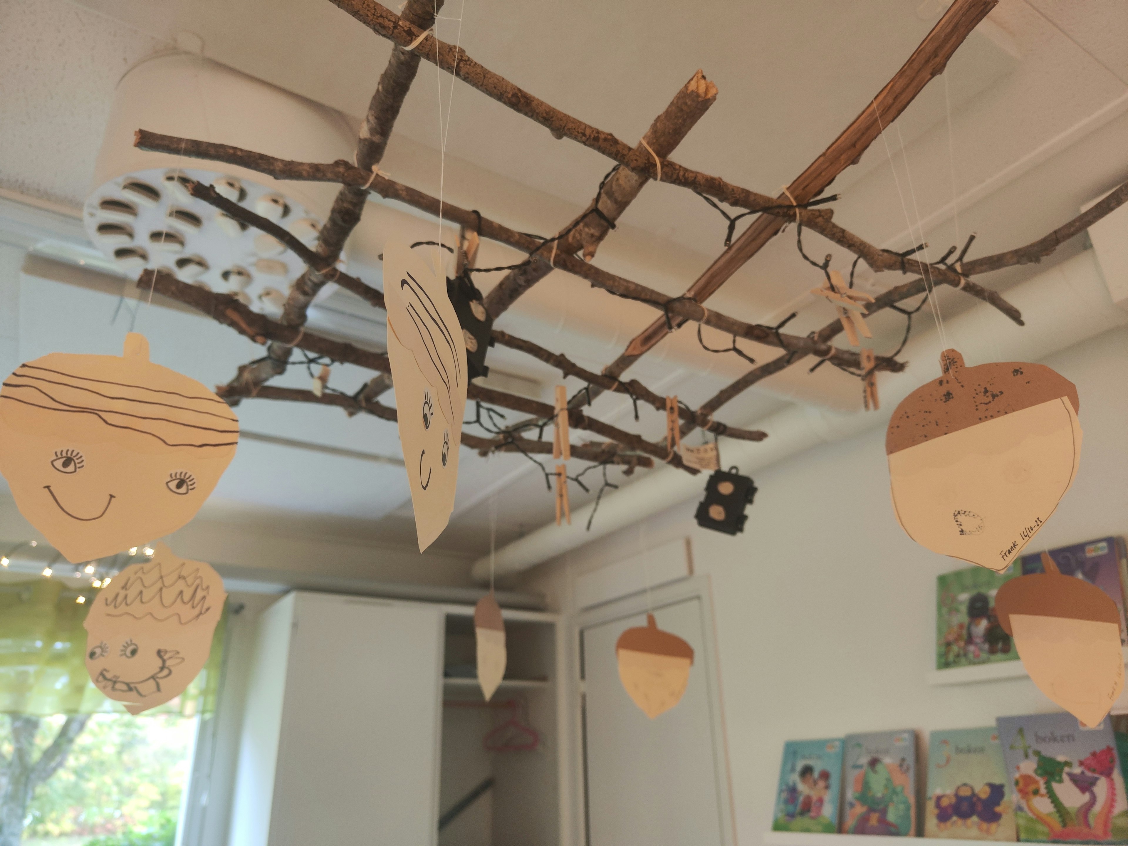 Interior view of a room with handmade decorations hanging from a branch