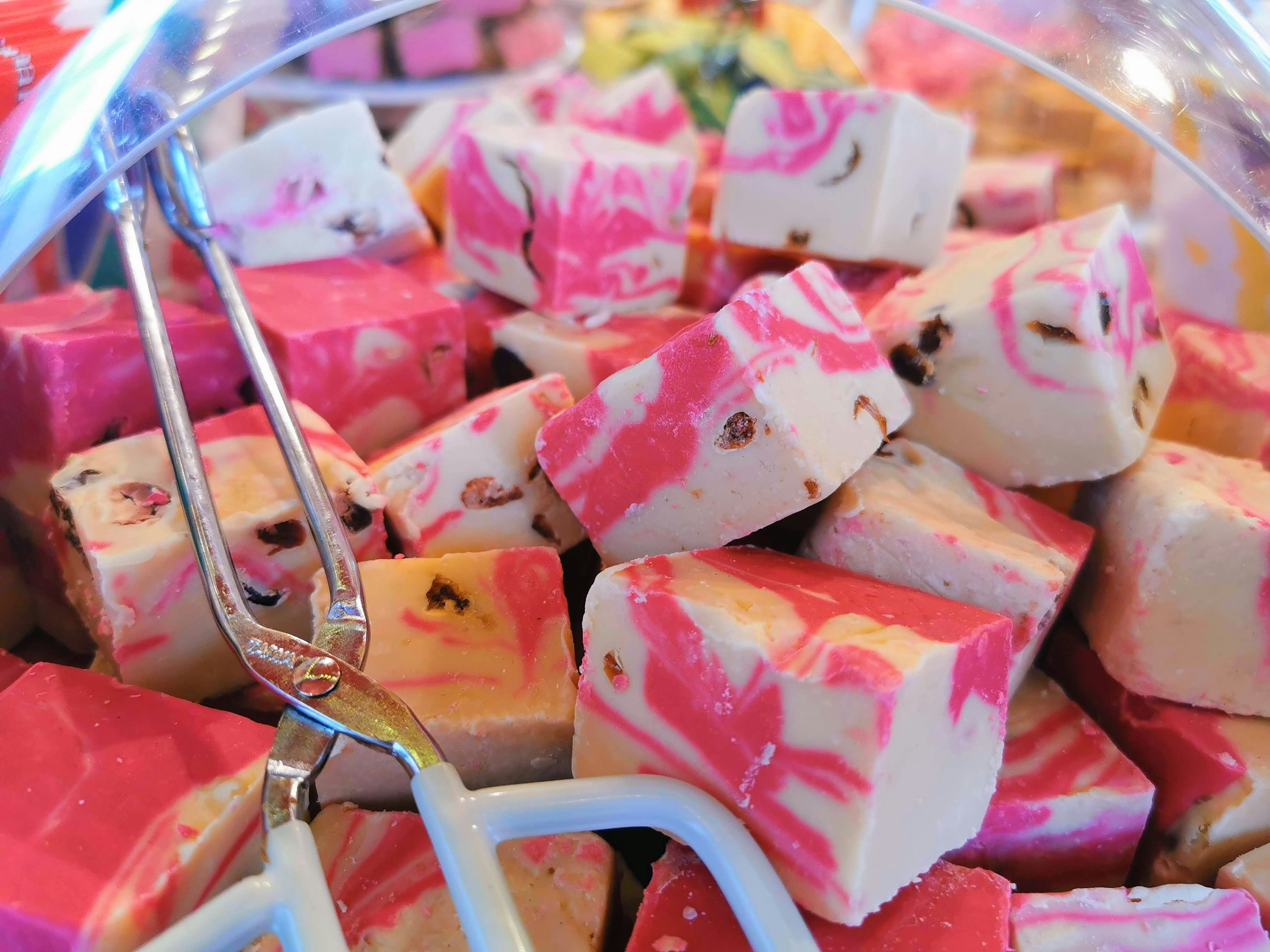 Colorful marbled candy pieces arranged in a glass container