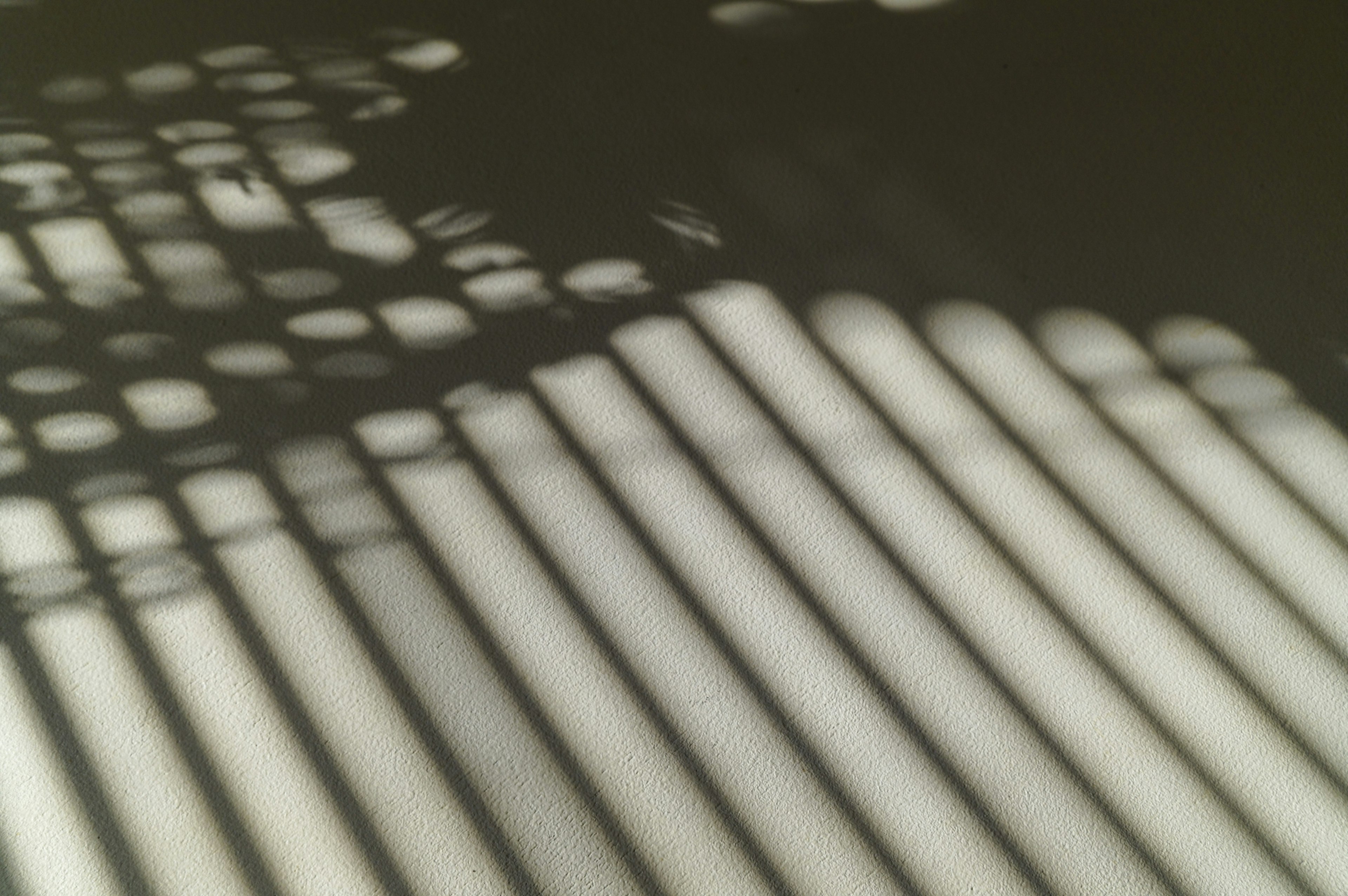 Abstract pattern of intersecting light and shadow stripes