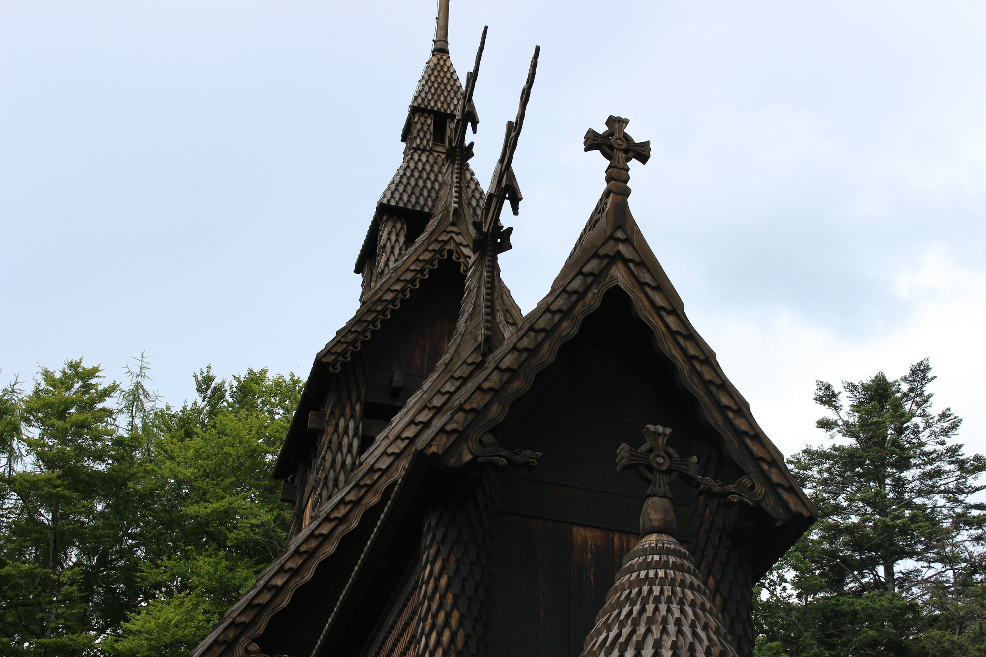 Unique wooden church roof with spires and crosses