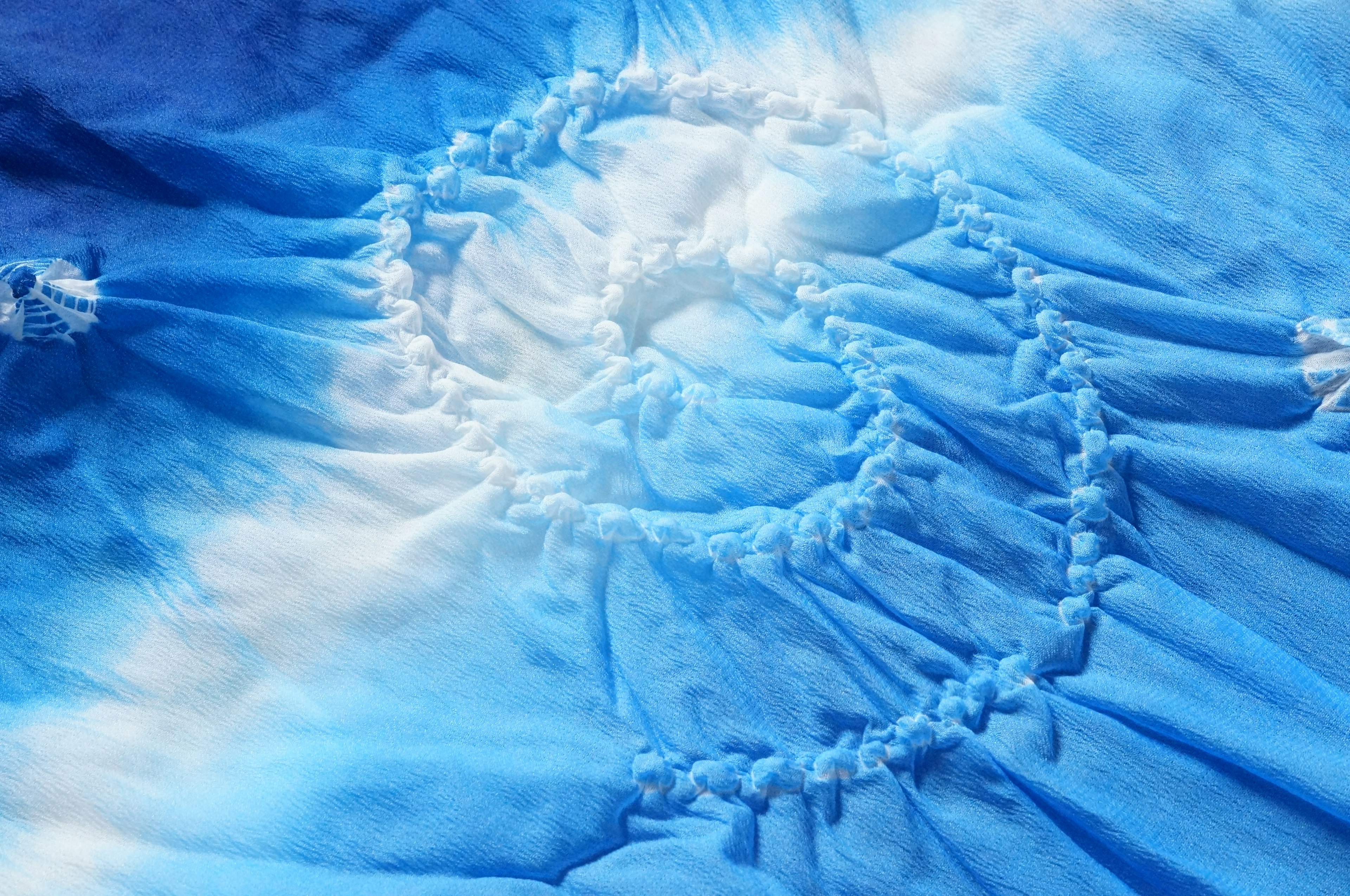 Blue tie-dye fabric featuring a spiral pattern