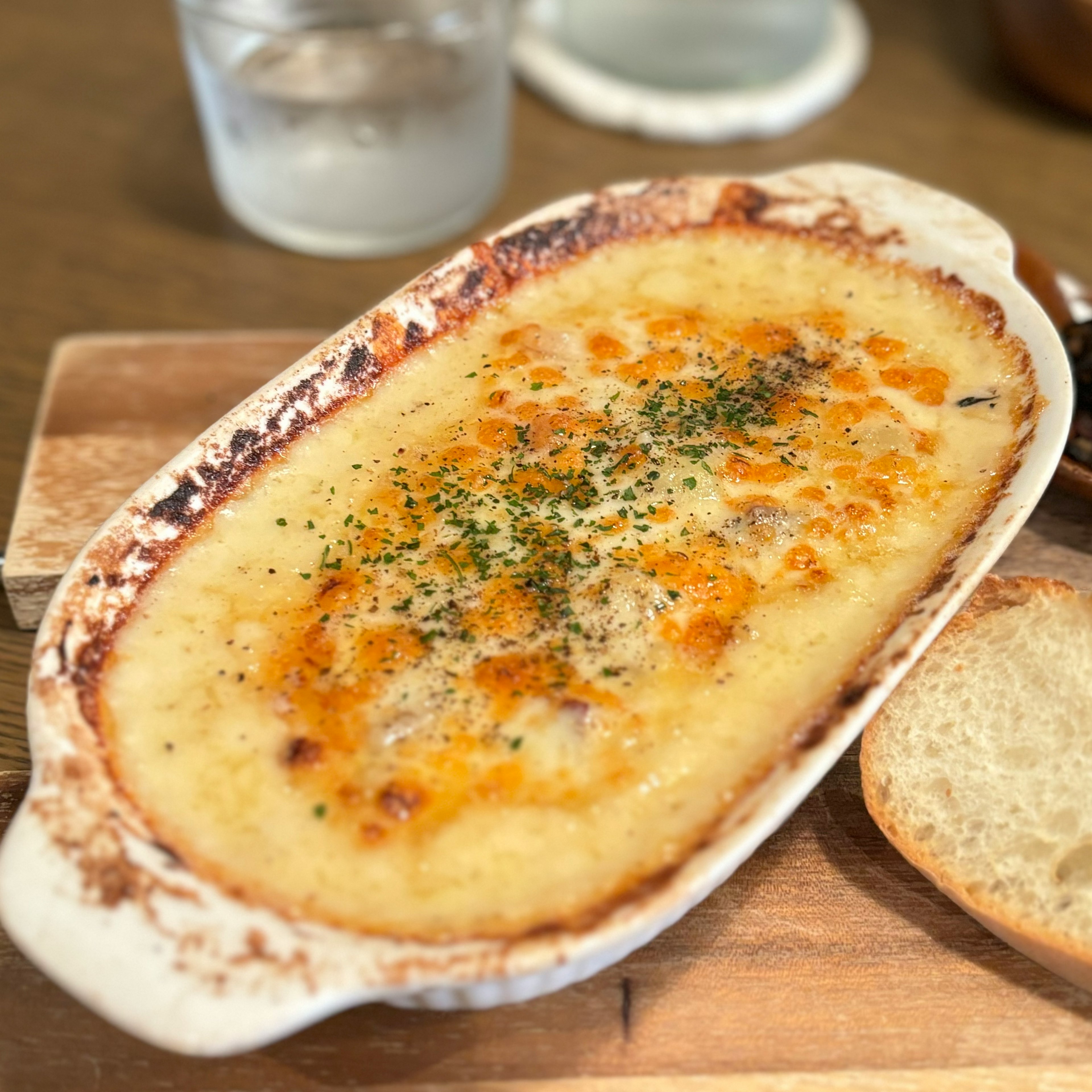 Foto di un gratin cremoso al formaggio in un piatto di ceramica