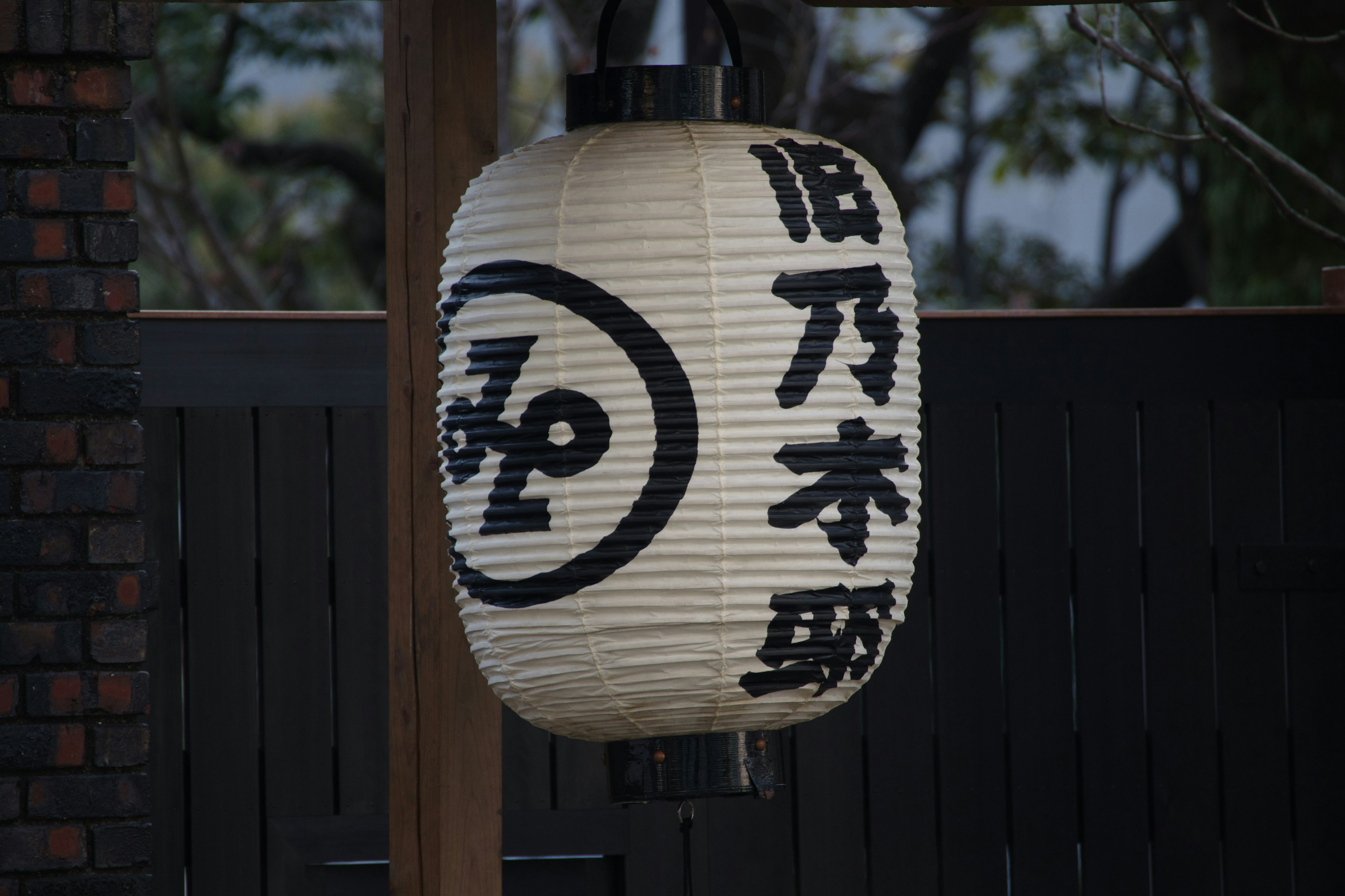 A white lantern with black characters and a symbol