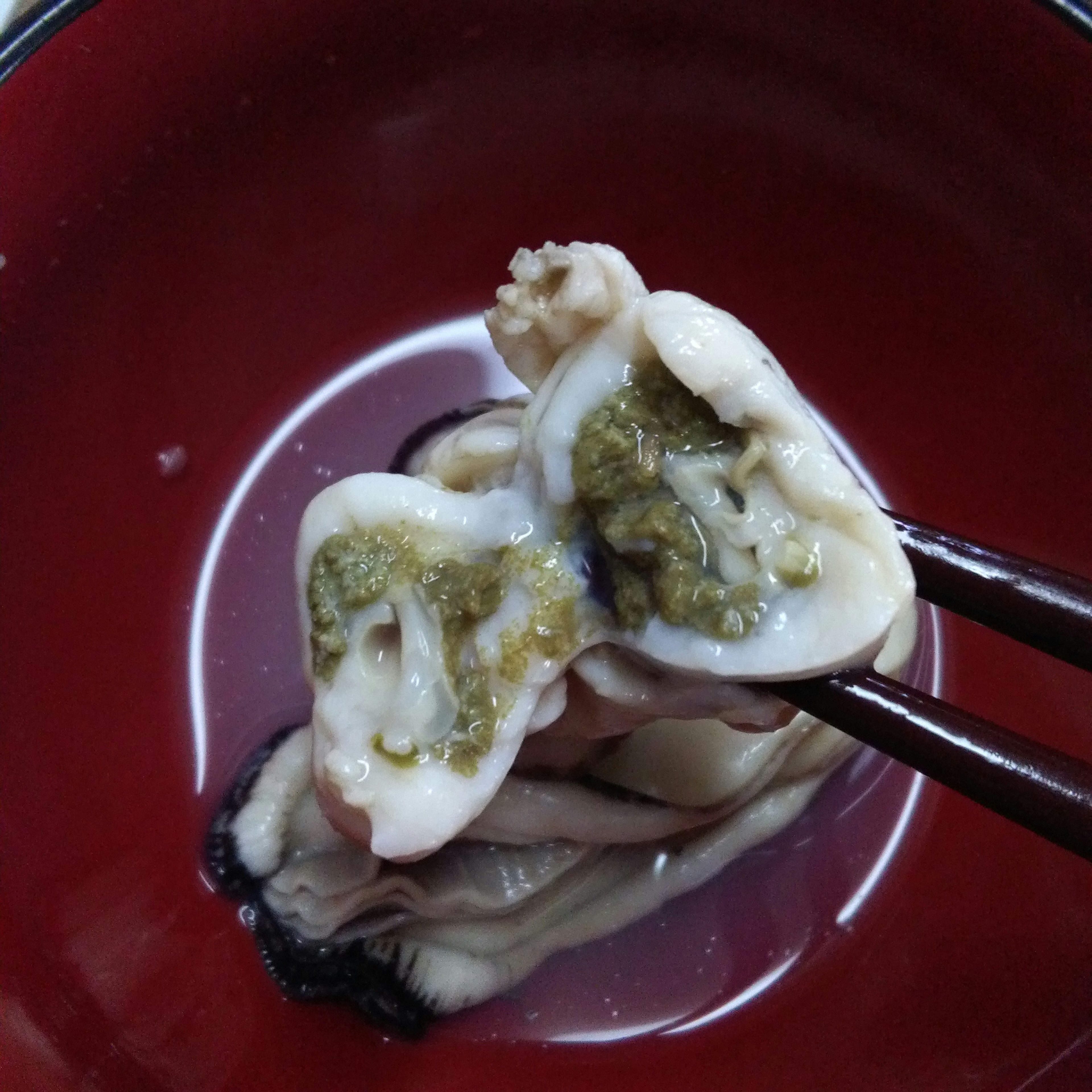 Cross-section of raw shellfish displayed in a red bowl