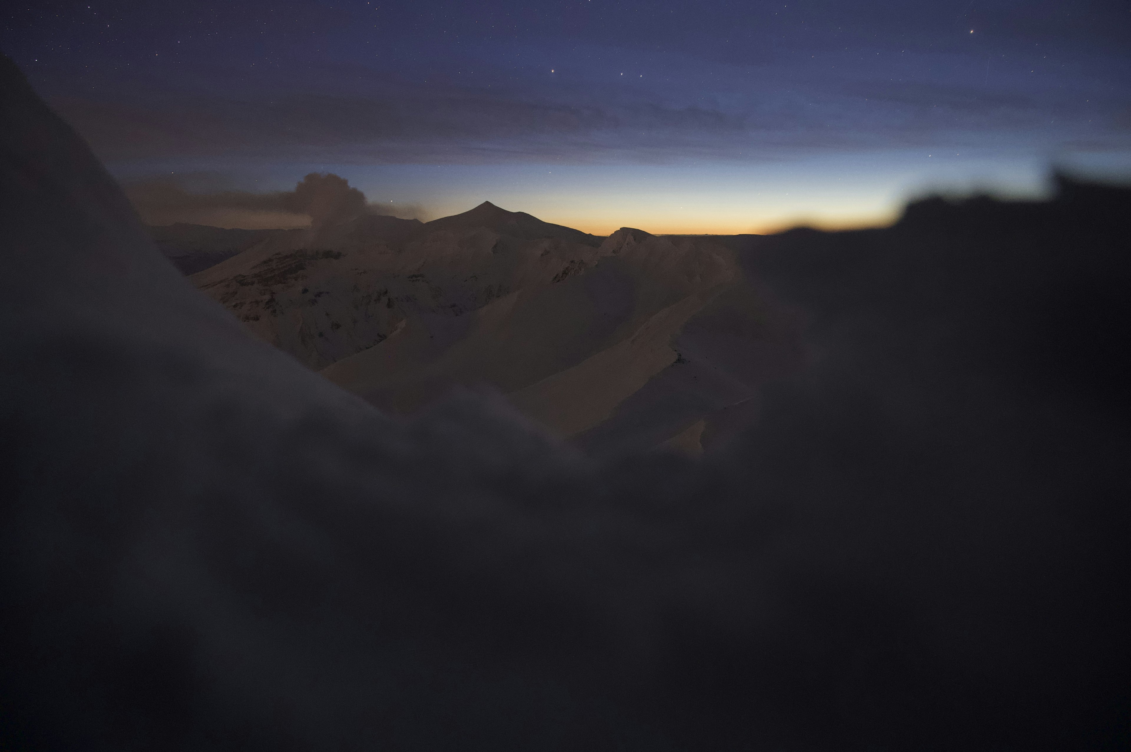 Paysage montagneux dramatique à l'aube avec un ciel étoilé