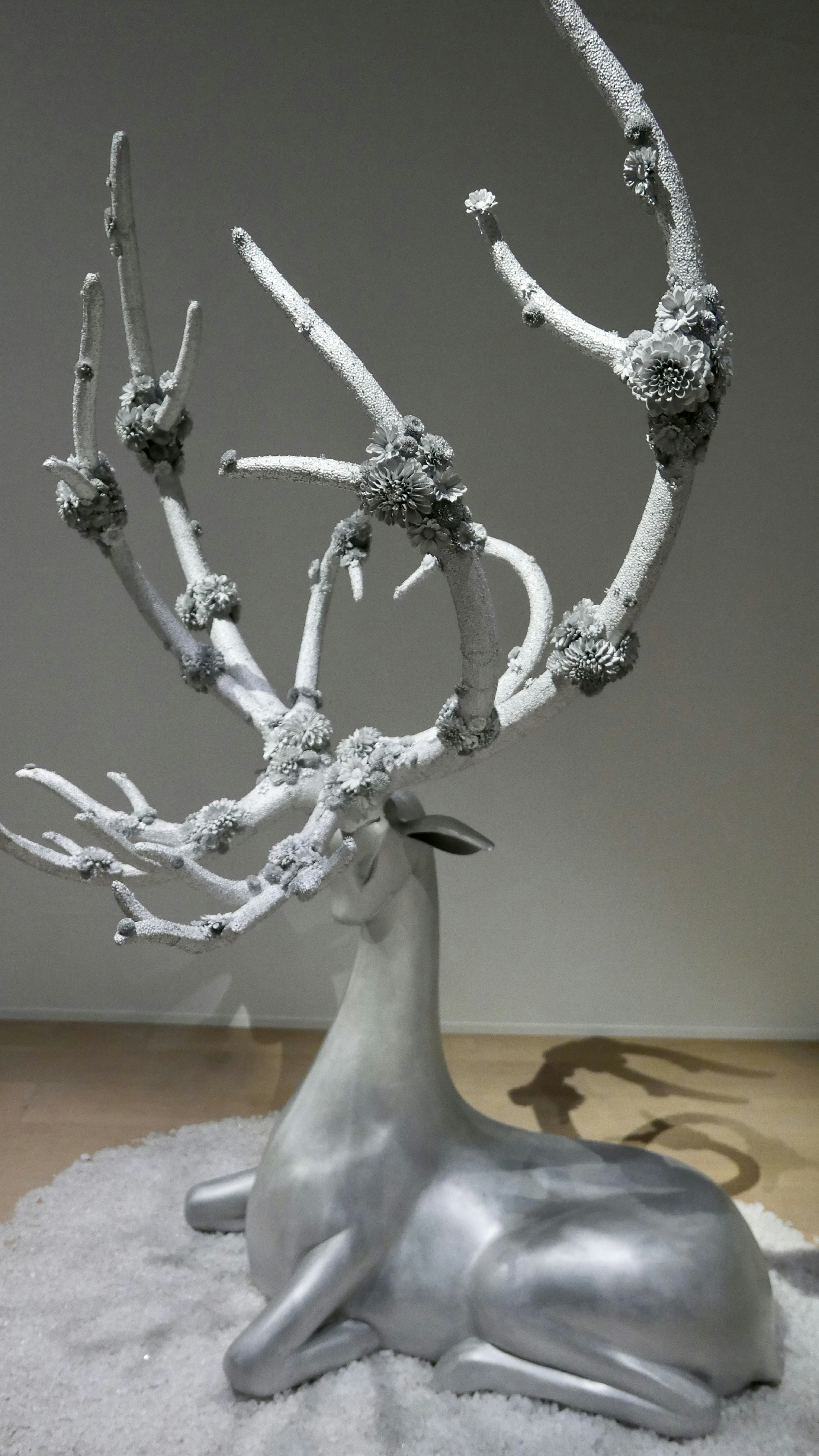 Silver deer sculpture with branch-like antlers