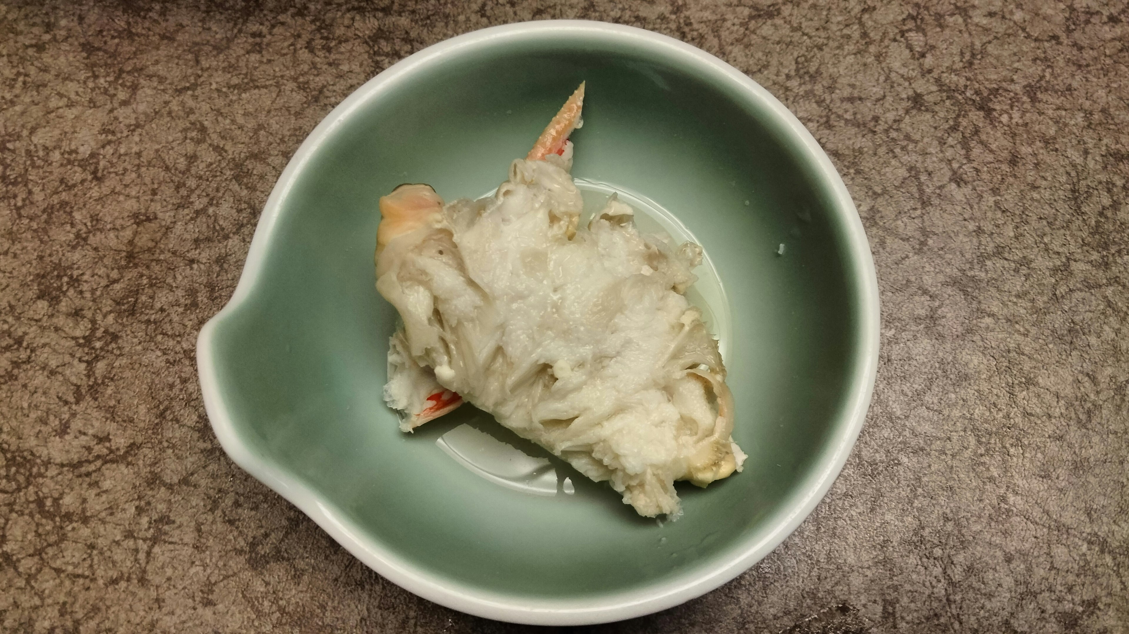 White fish dish served in a green bowl