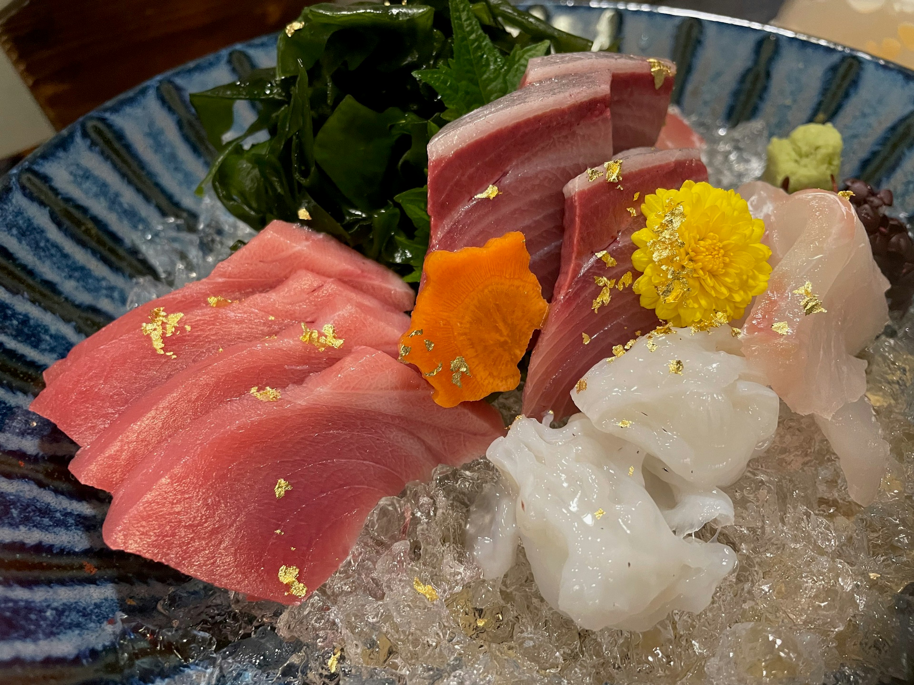 Beautiful sashimi platter featuring fresh fish and gold leaf decoration