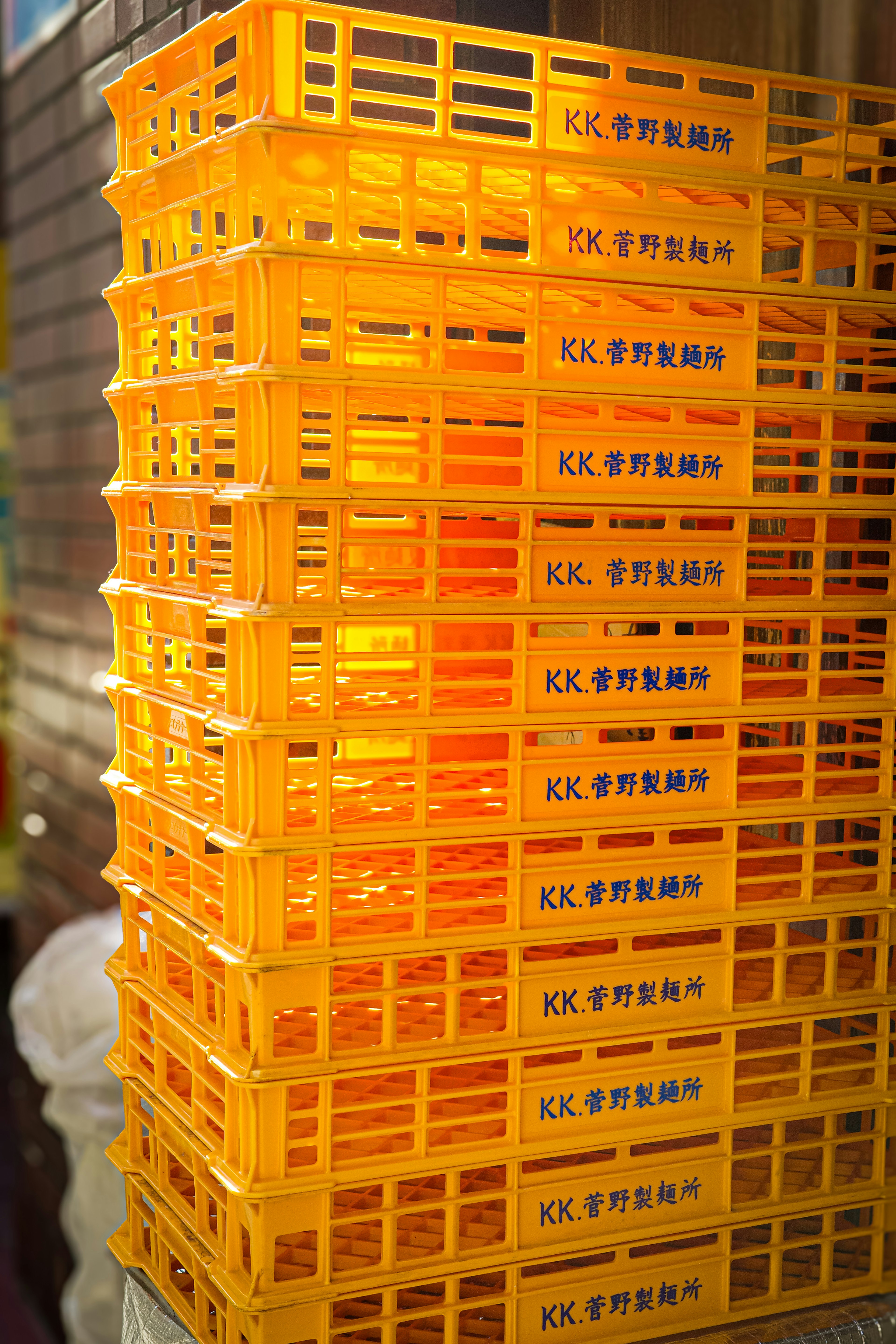 Stacked orange plastic crates arranged neatly