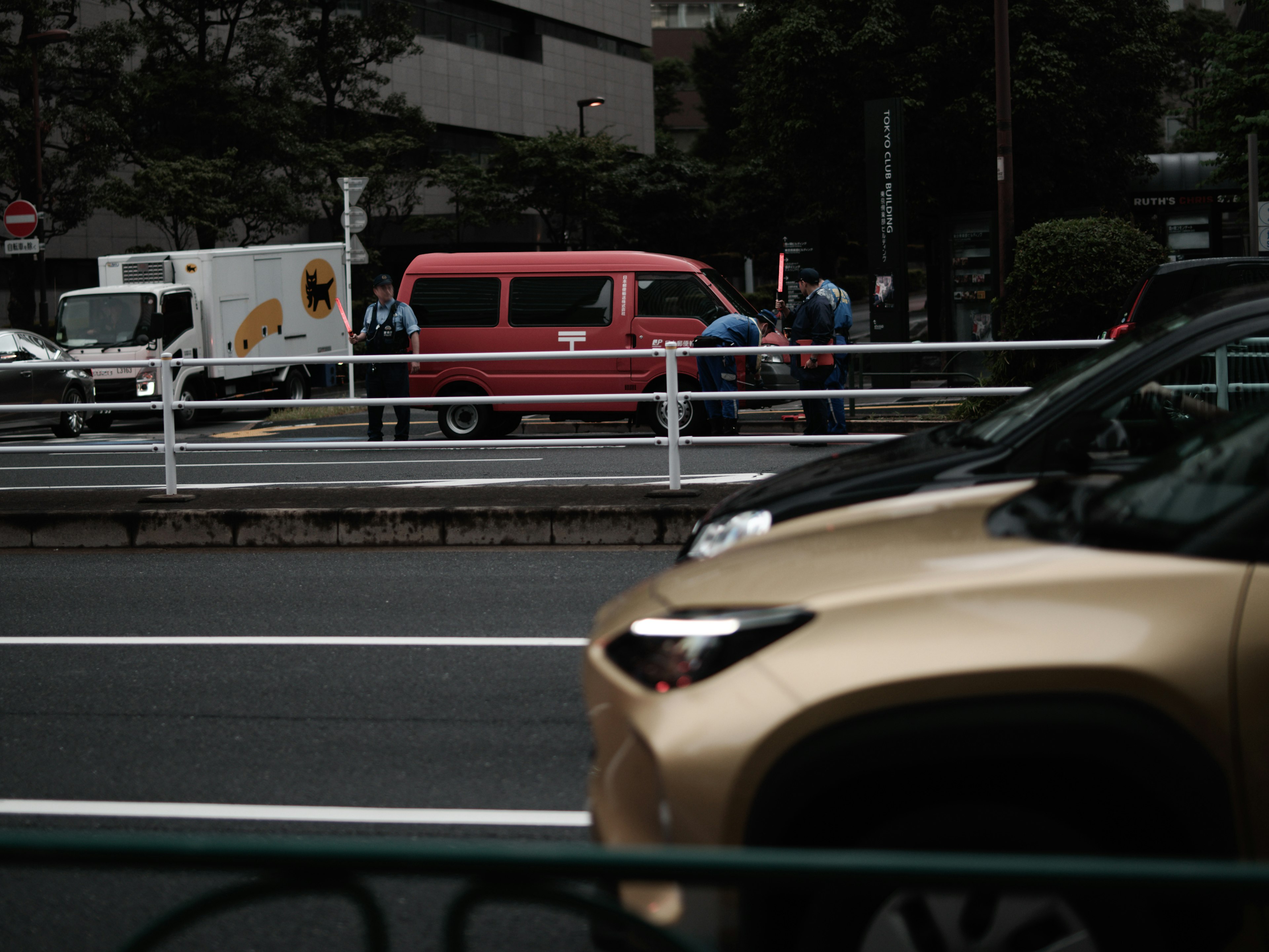 Urban scene with a red van and a truck parked