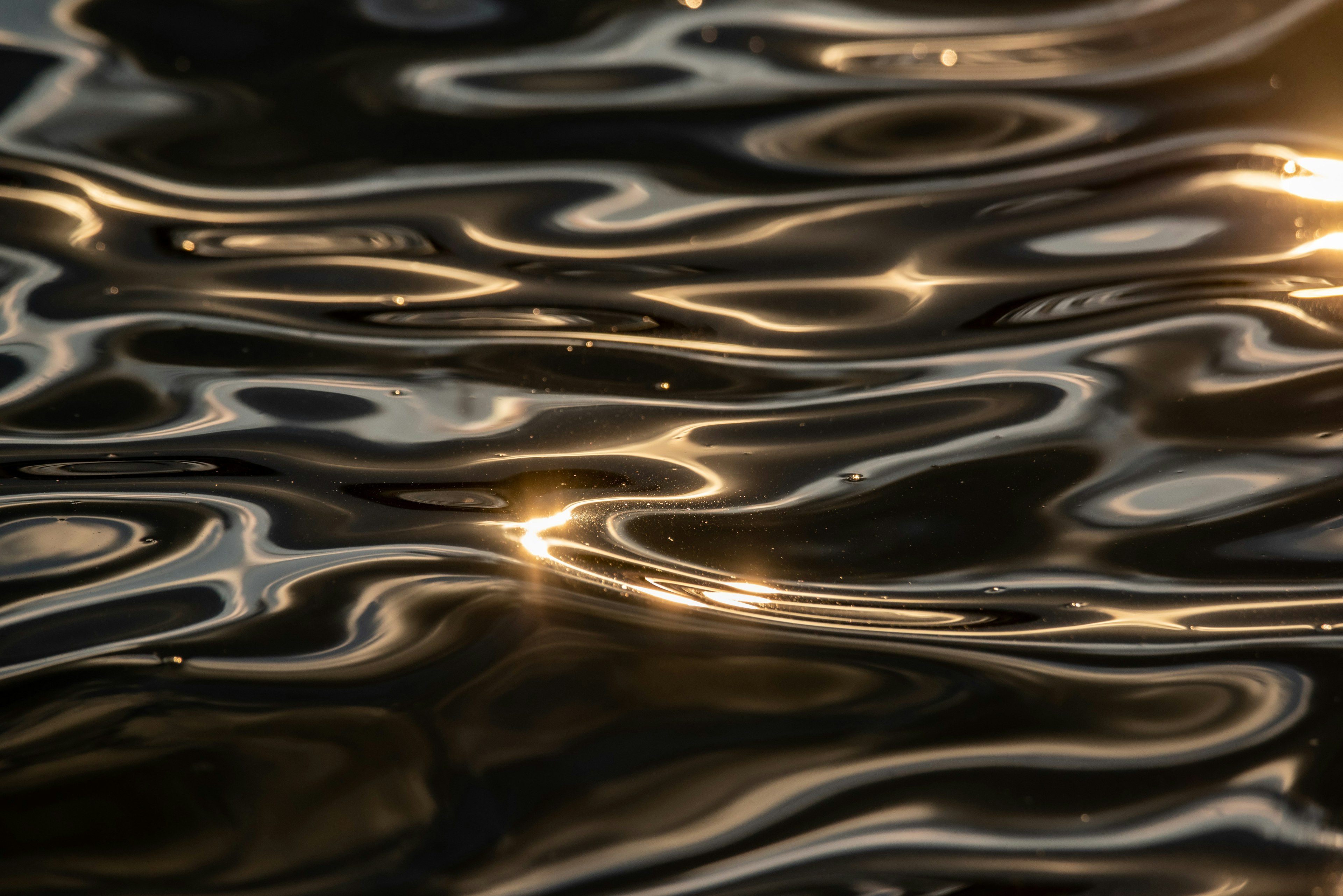 Beautiful patterns of light reflection and ripples on water surface