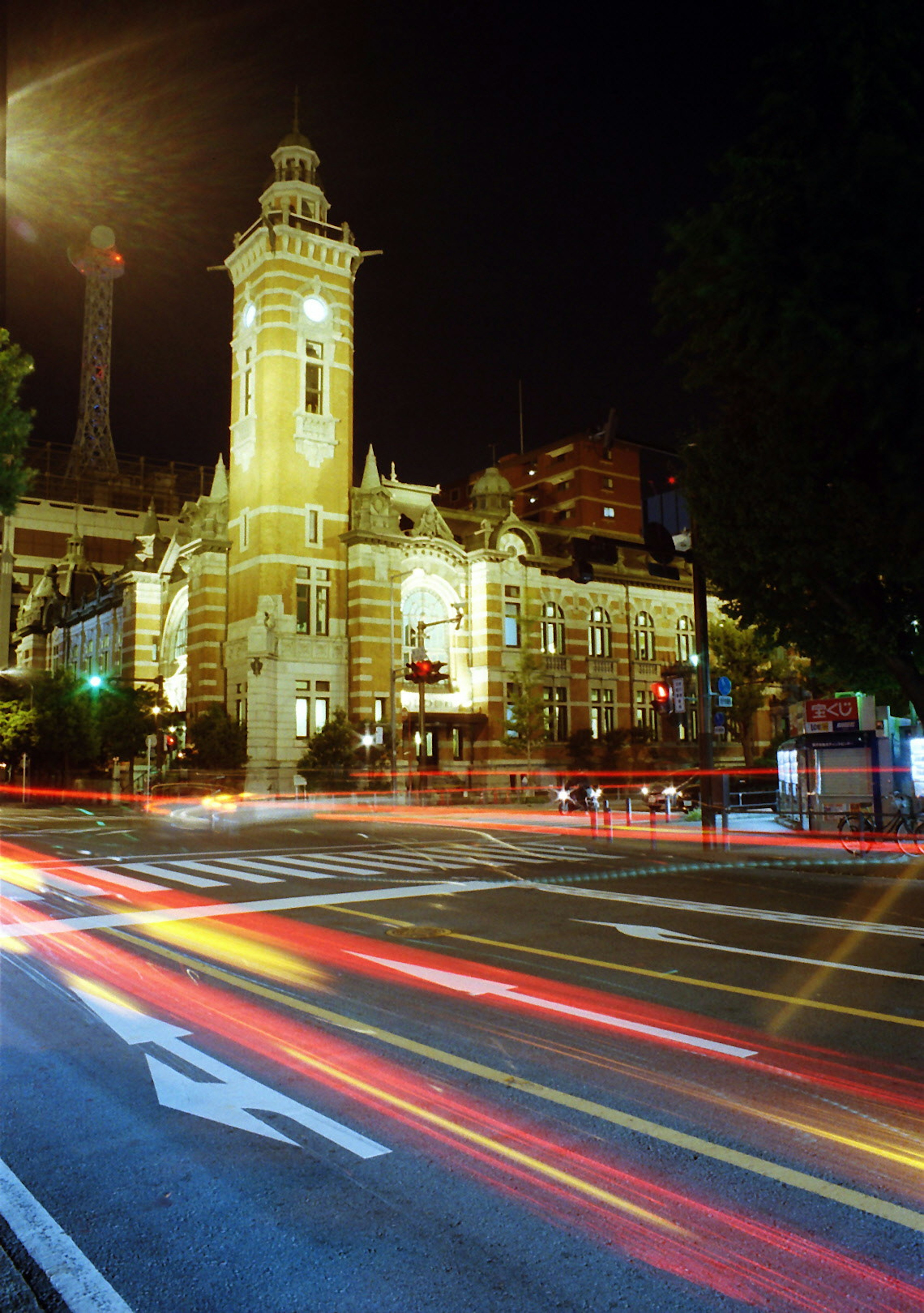 Nighttime cityscape featuring a beautifully lit historic town hall building