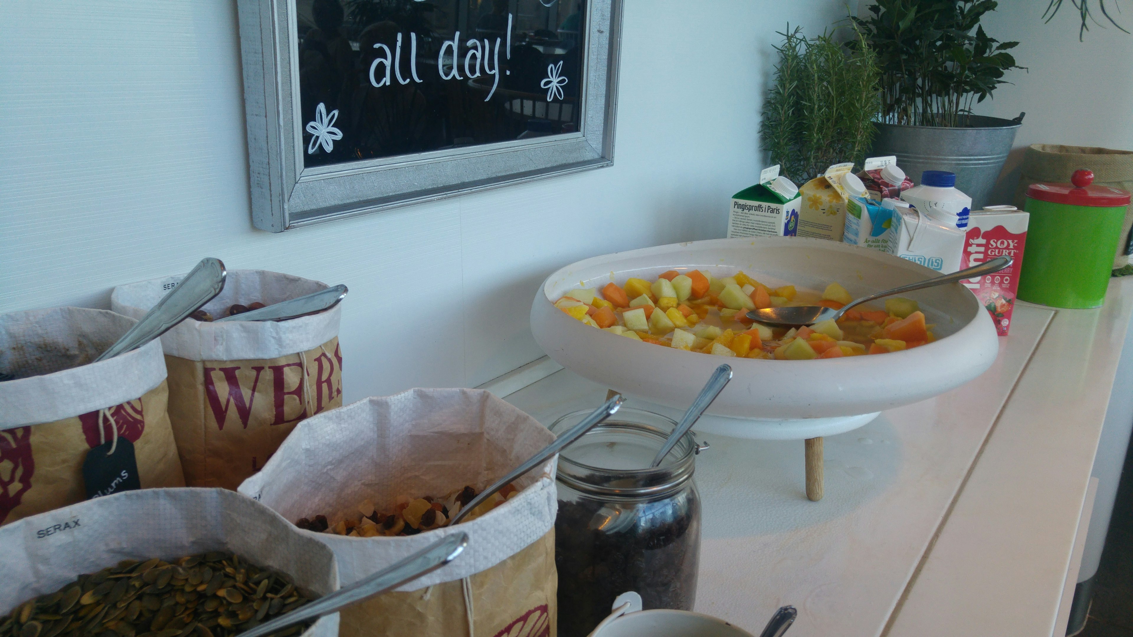 Buffet-style table featuring fruit salad and various toppings