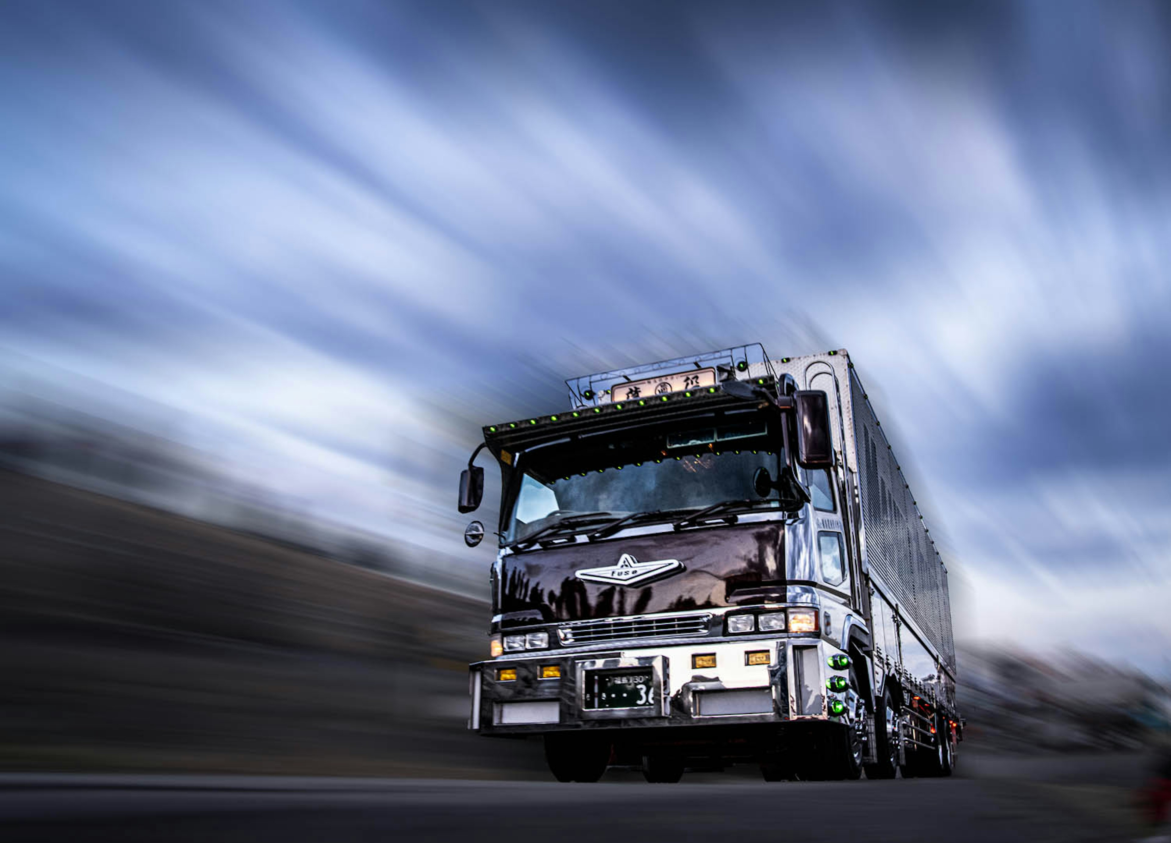 A dynamic large truck speeding on a highway